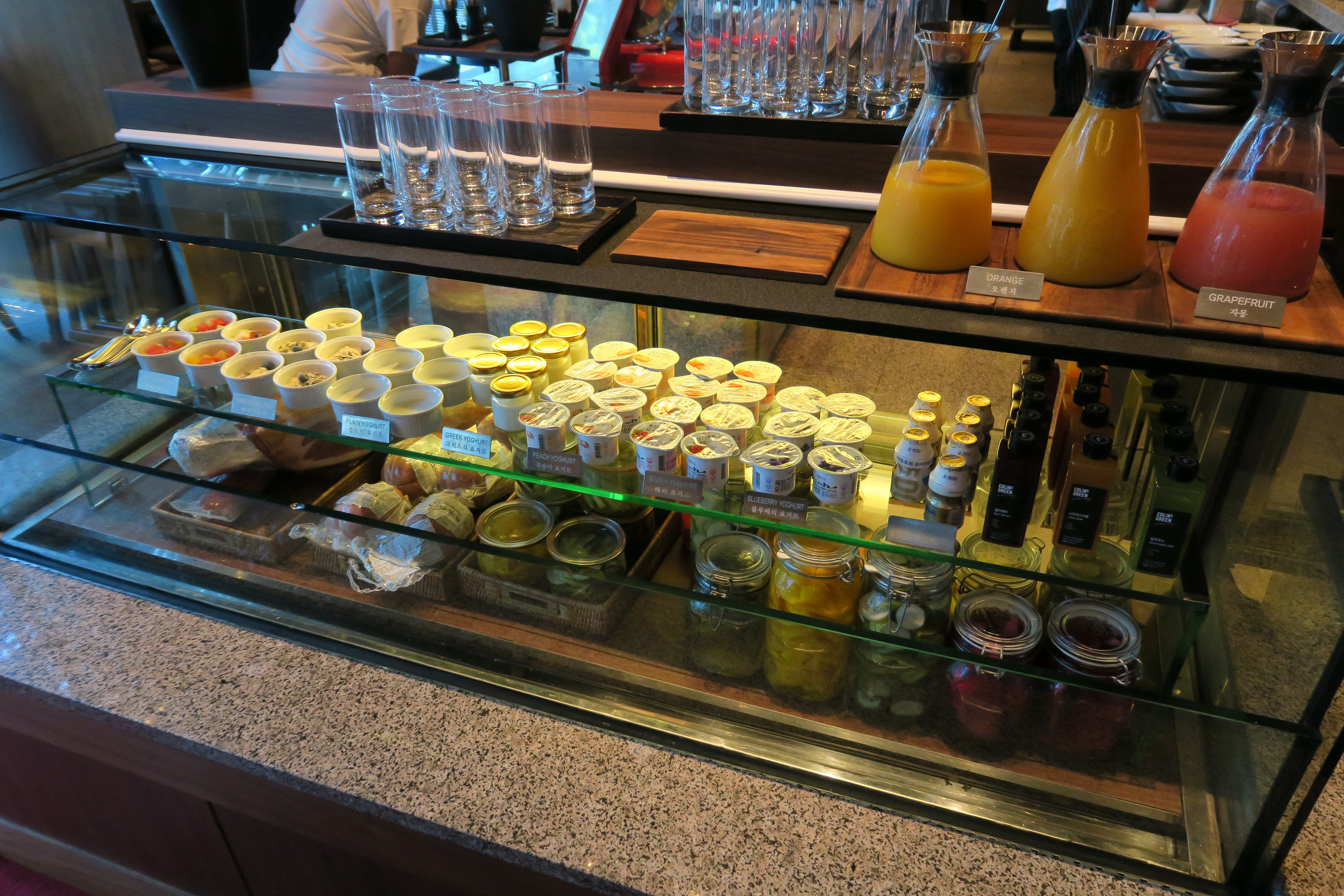 a glass display case with different types of food on it