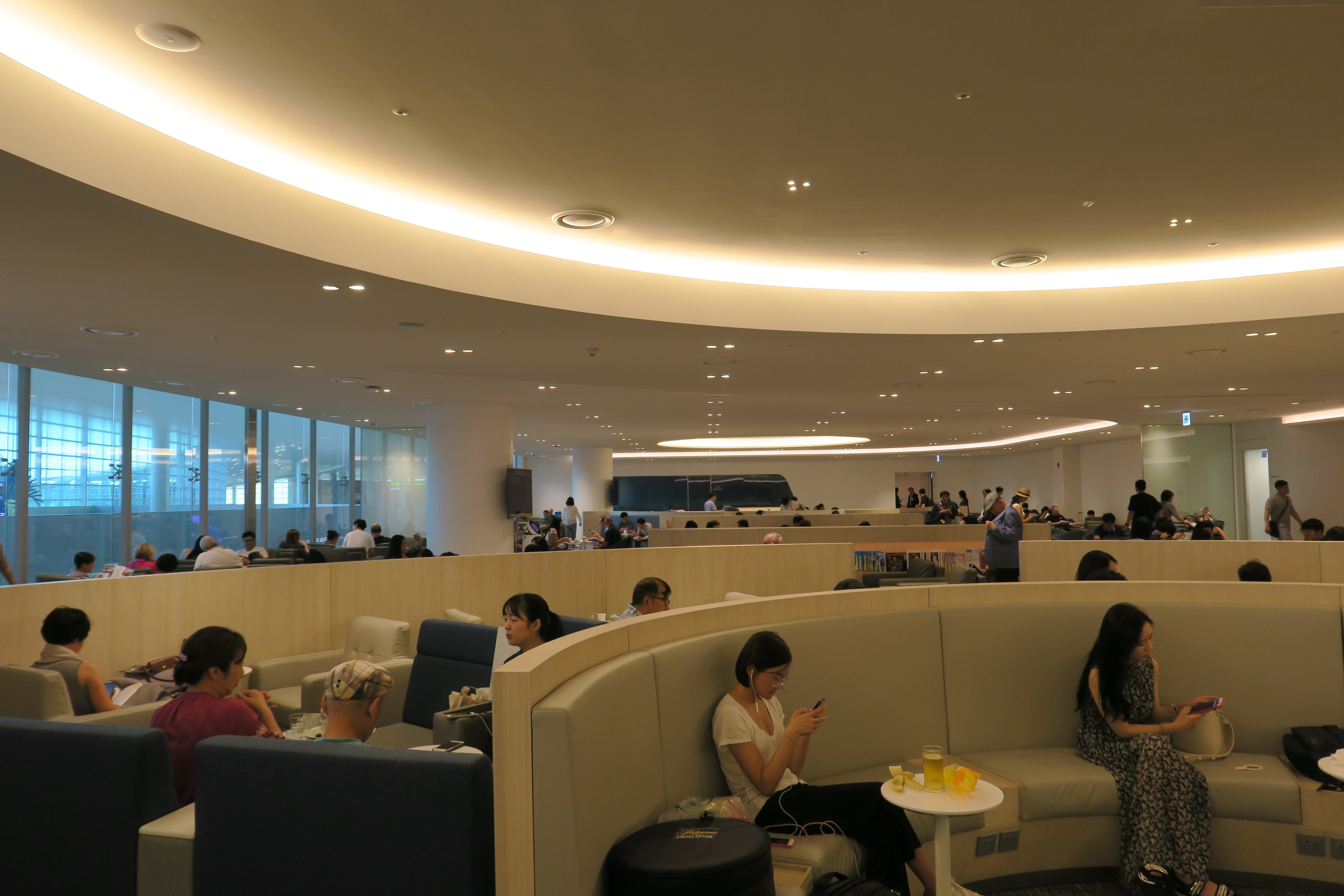 people sitting at tables in a large room