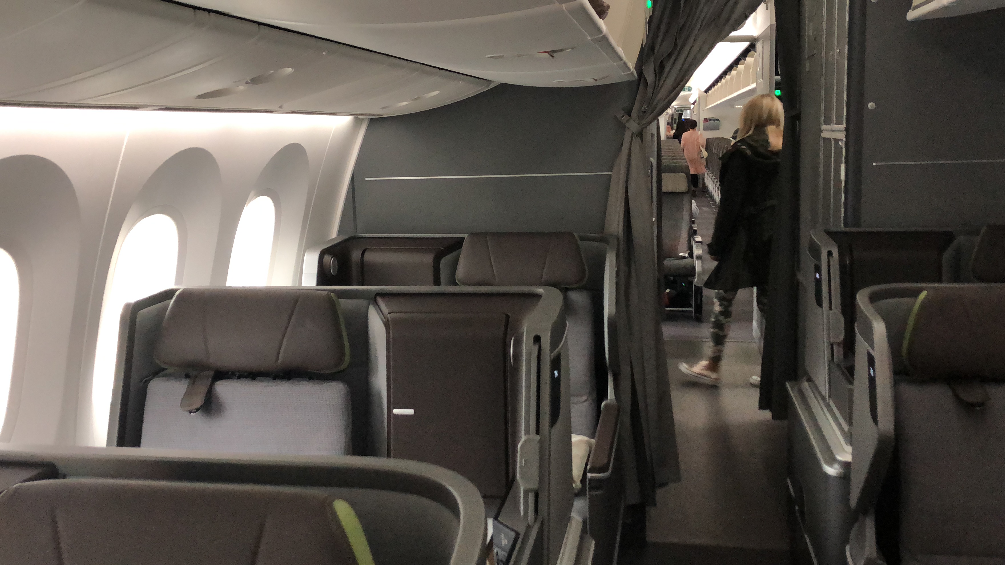a plane with seats and people walking