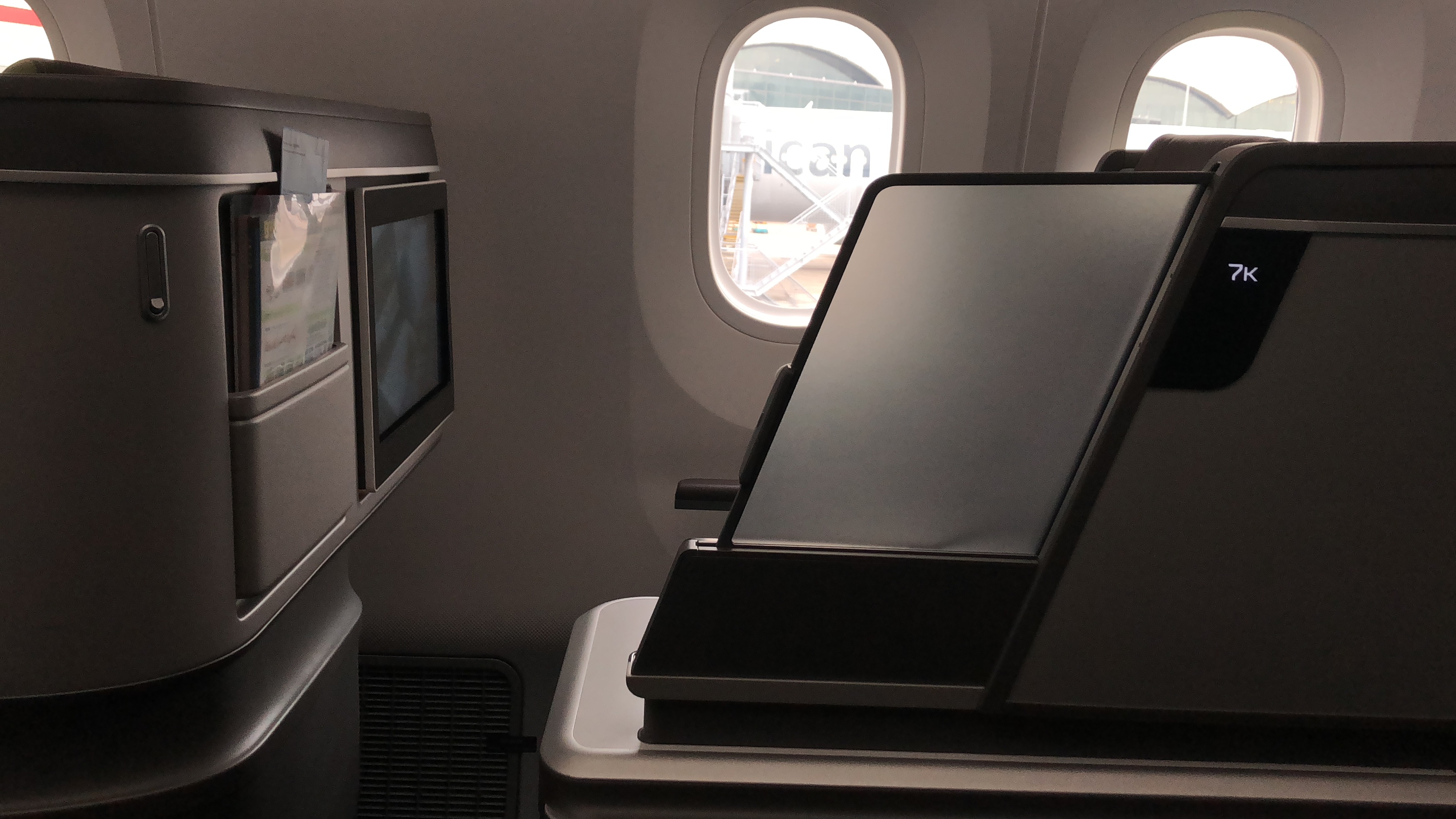 a screen on a table in an airplane