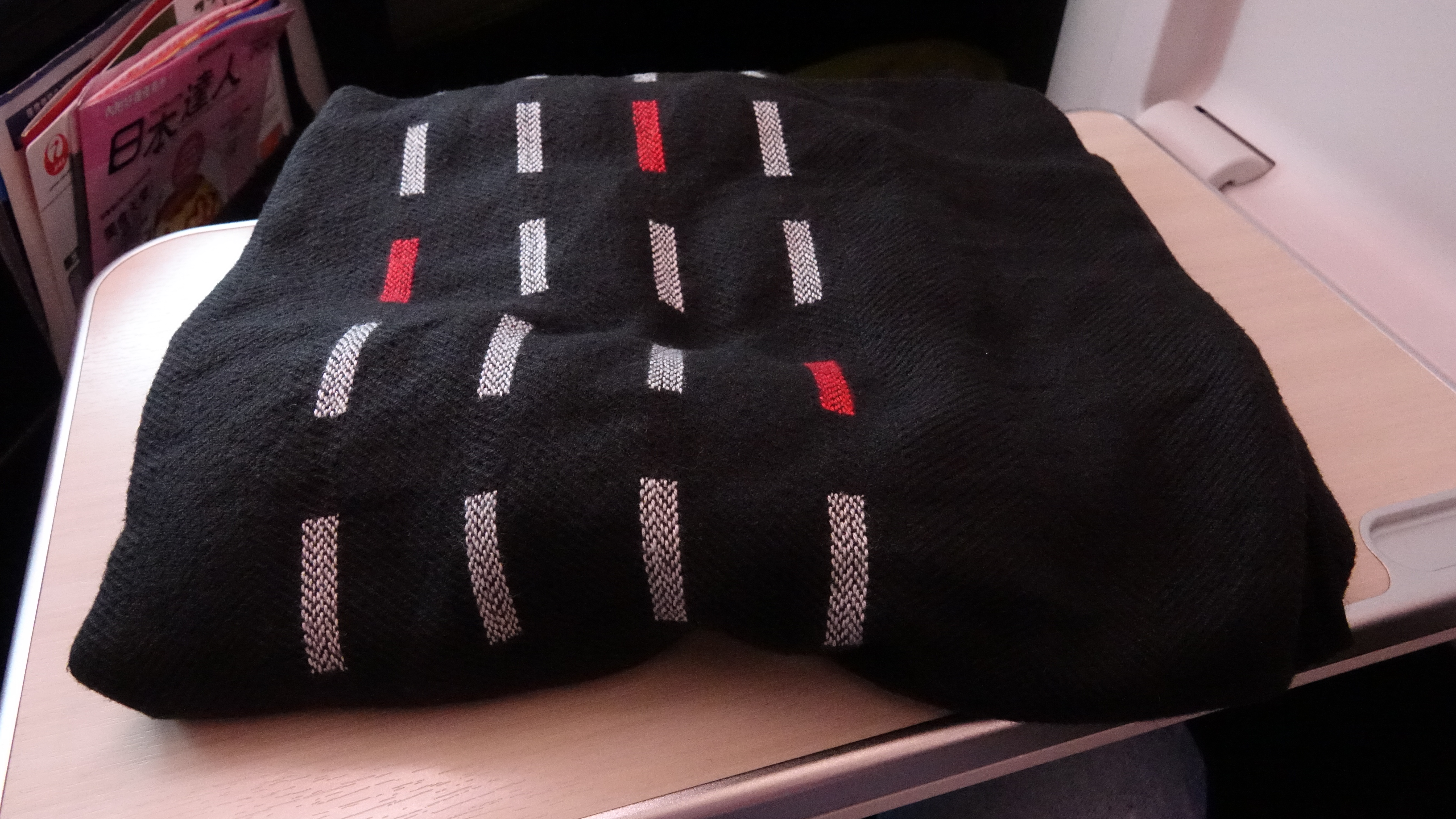 a black blanket with white and red stripes