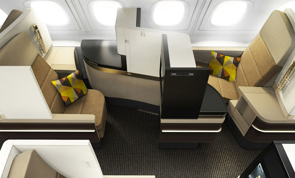 an airplane cabin with a desk and chairs