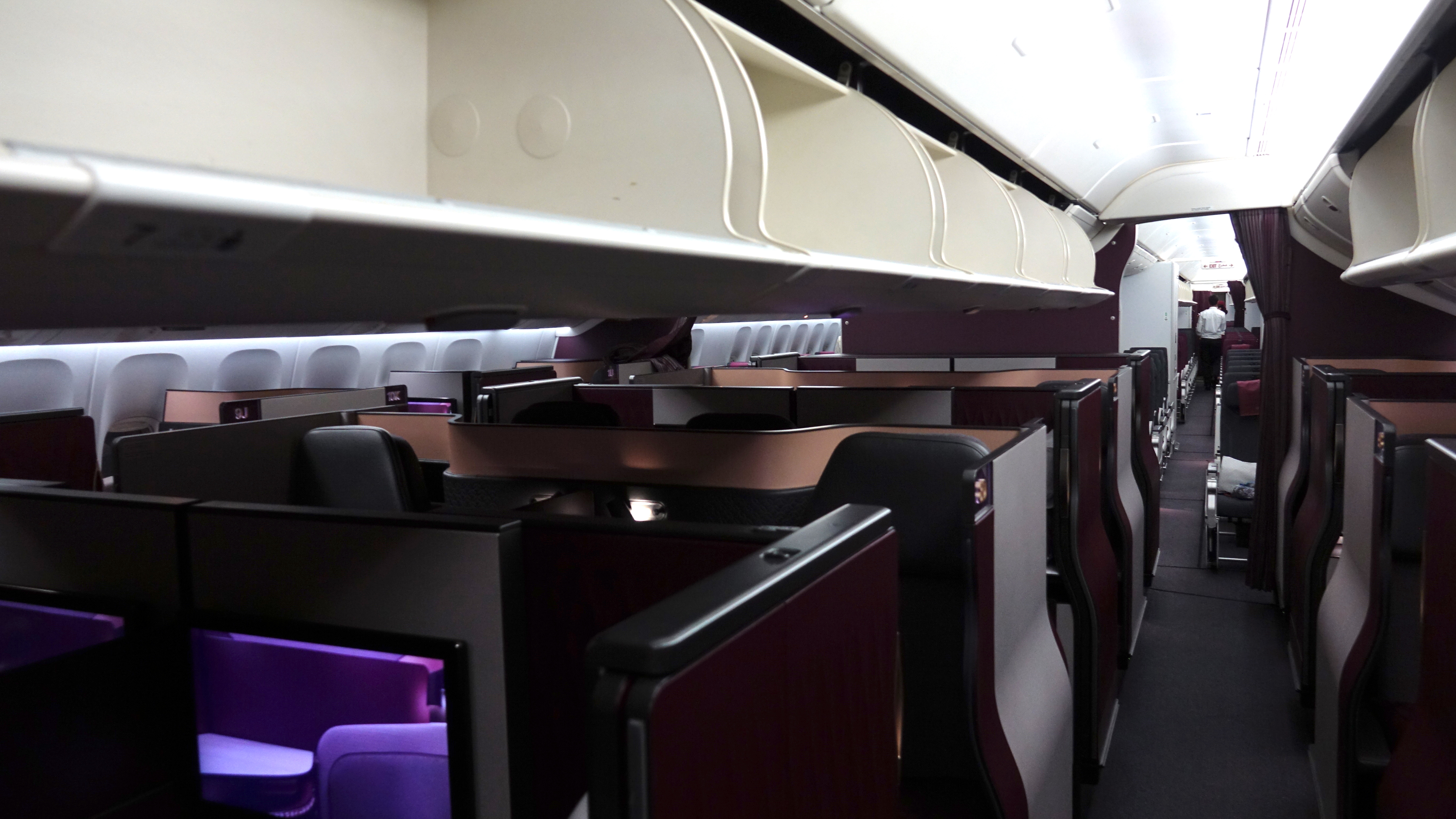 an airplane cabin with seats and a tv