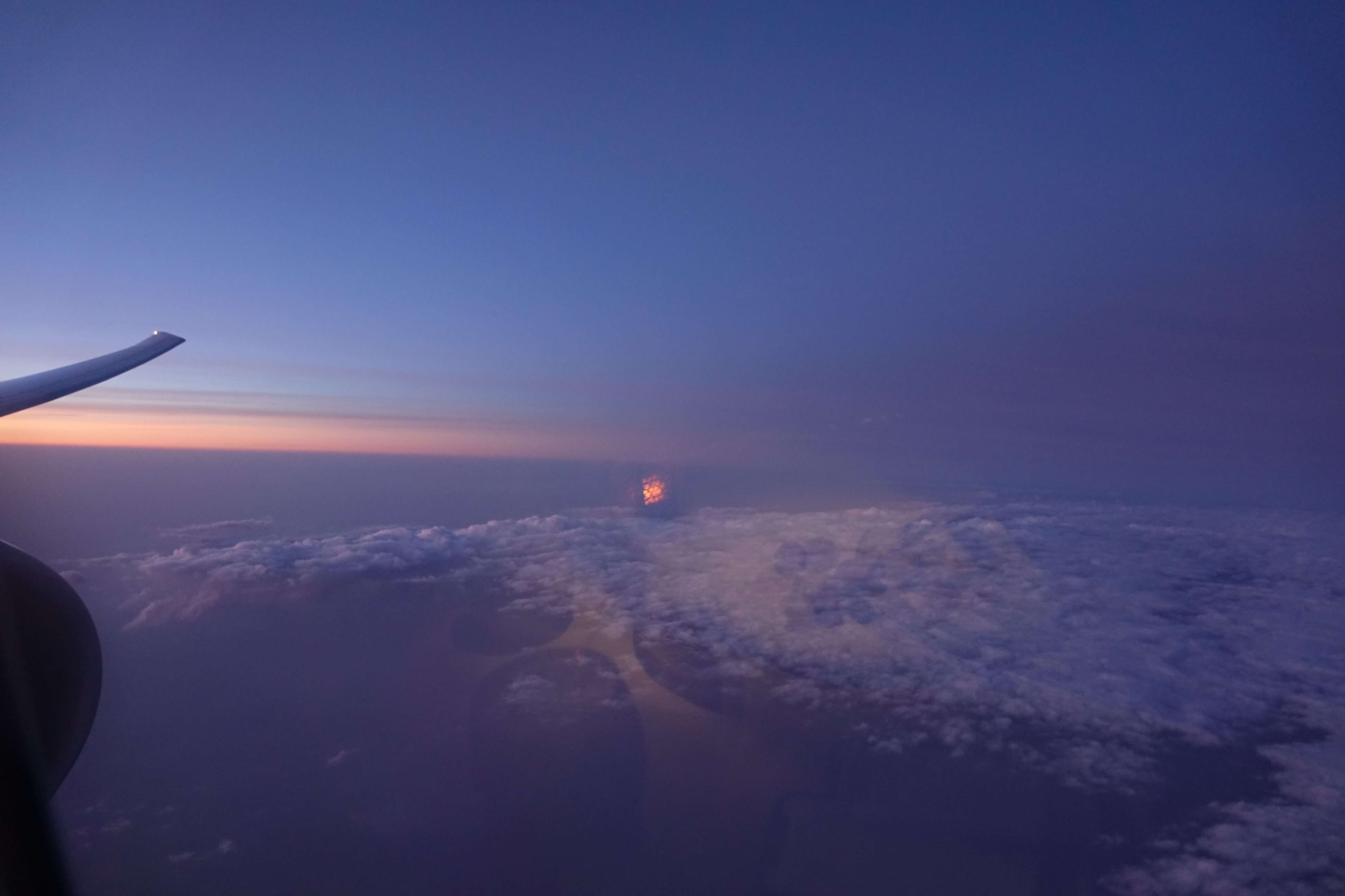 a view of clouds and a sunset from an airplane