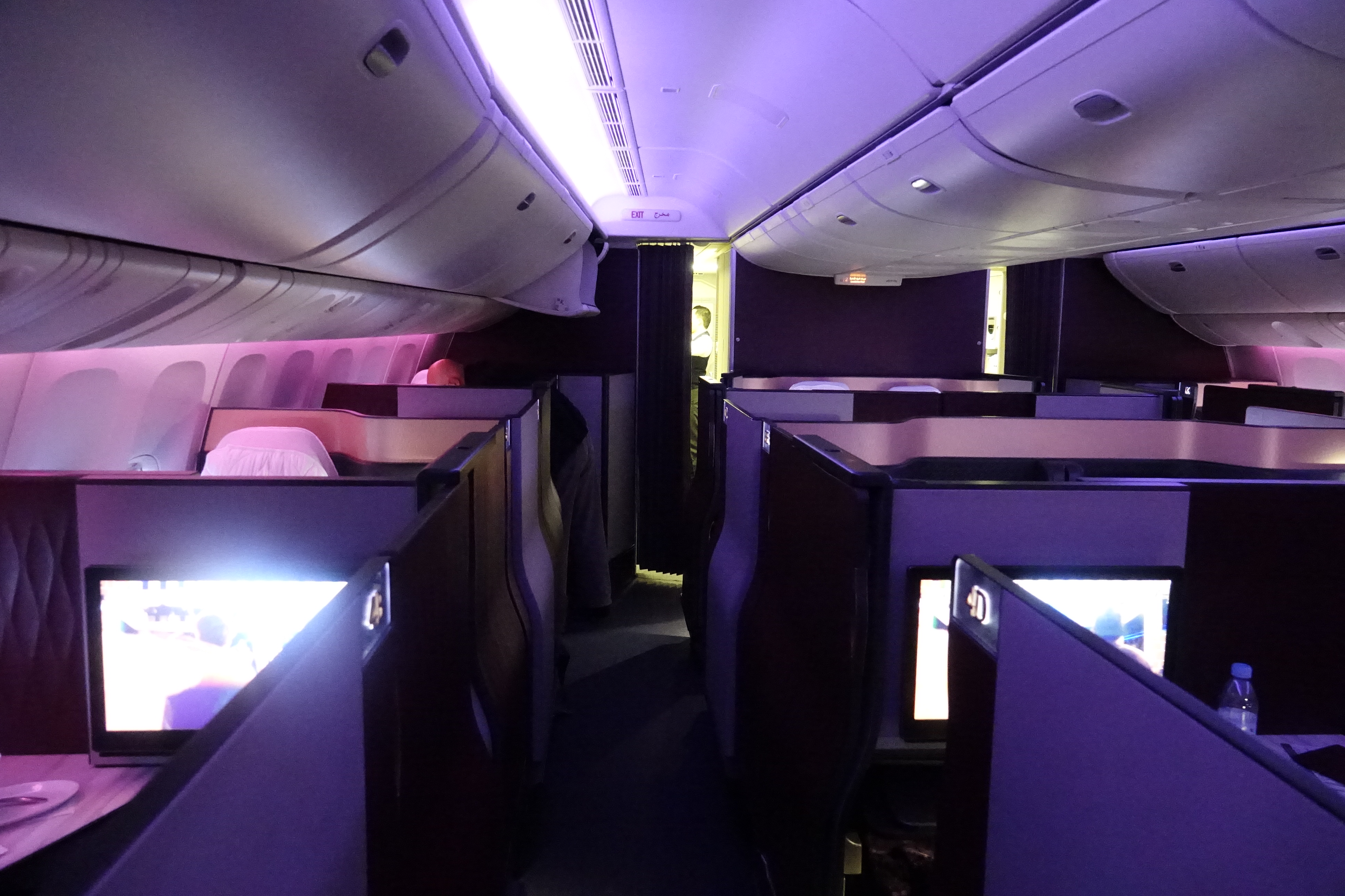 an inside of a plane with purple lights