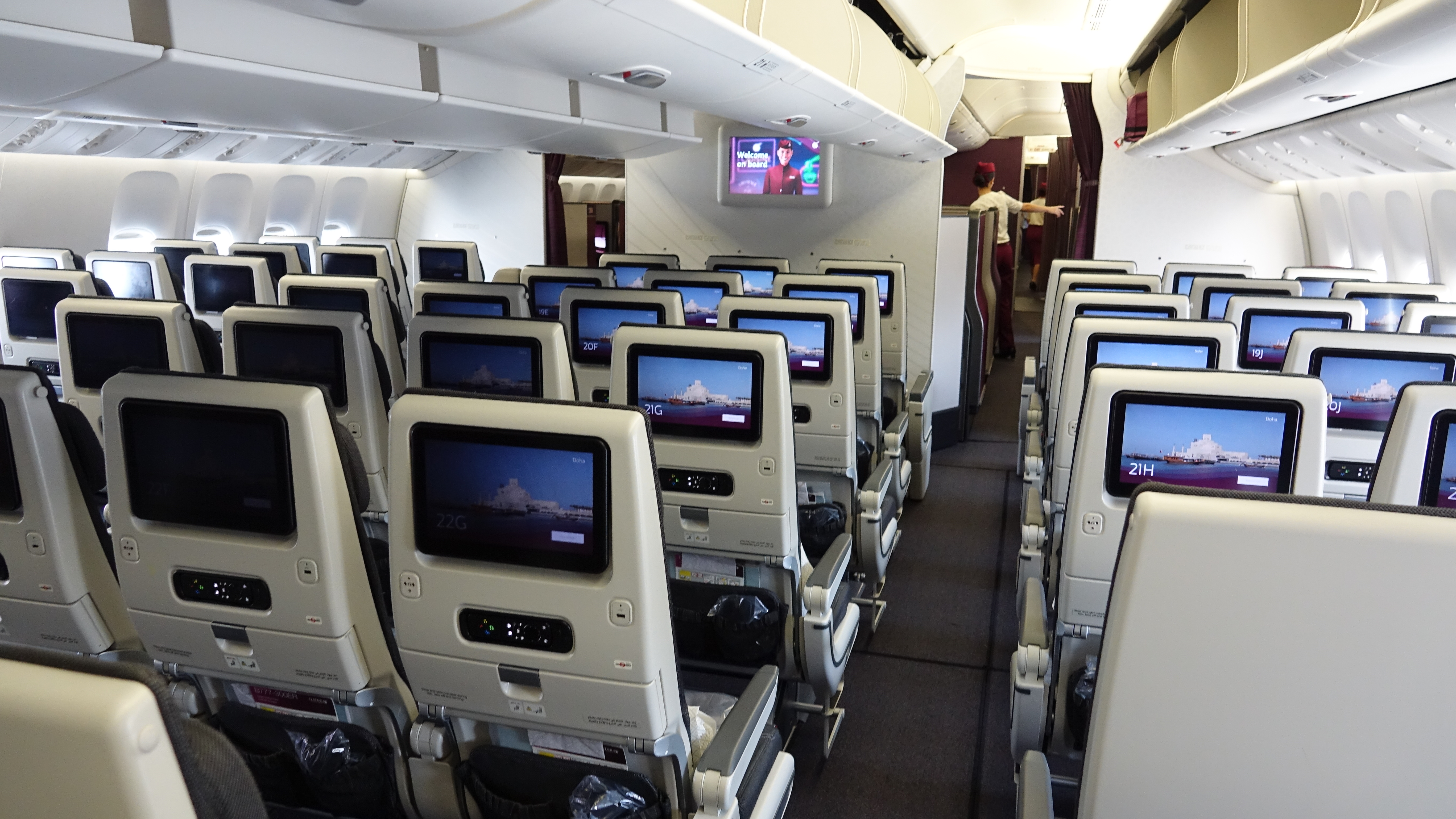 a row of seats with monitors on the back