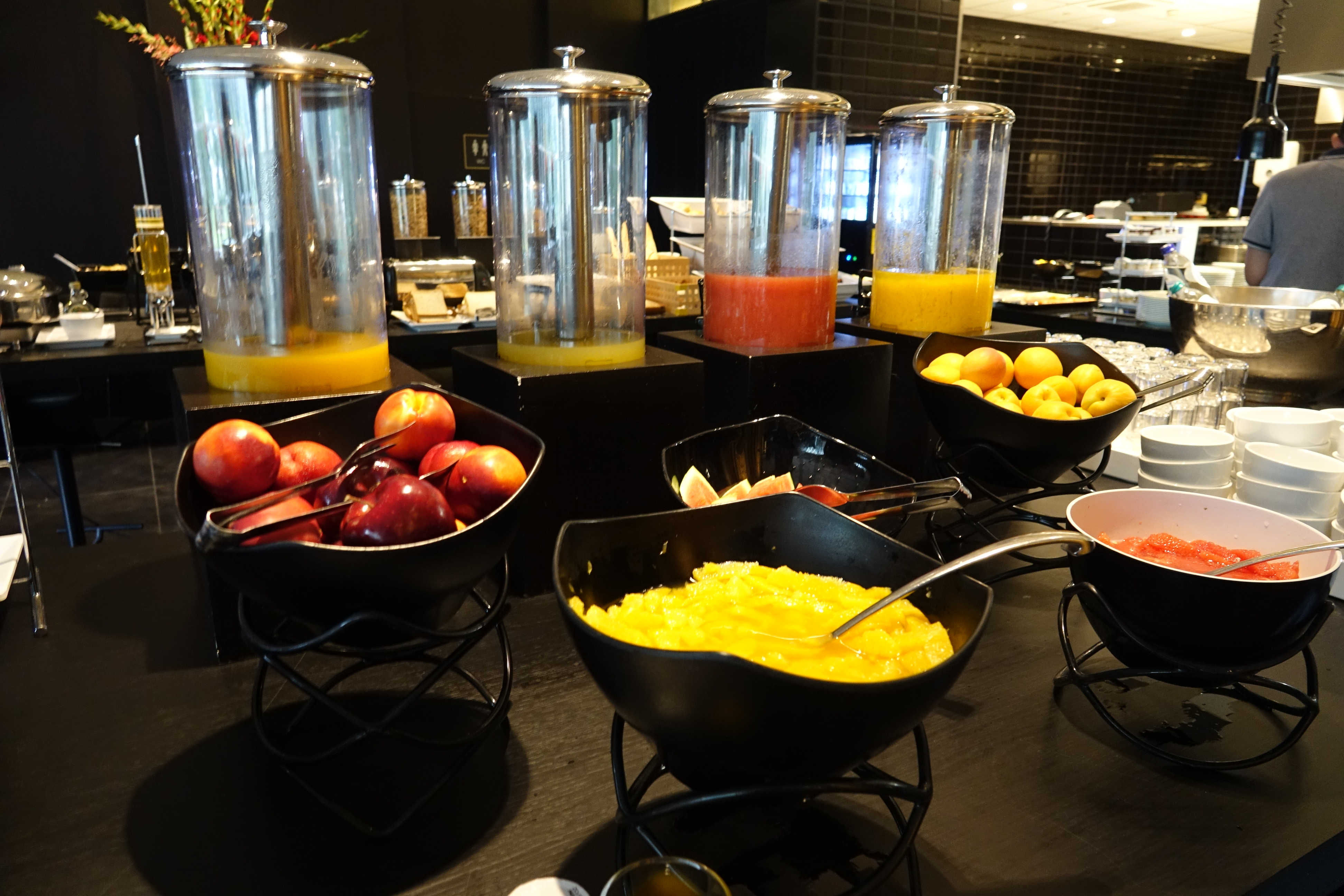 a buffet table with fruit and juices
