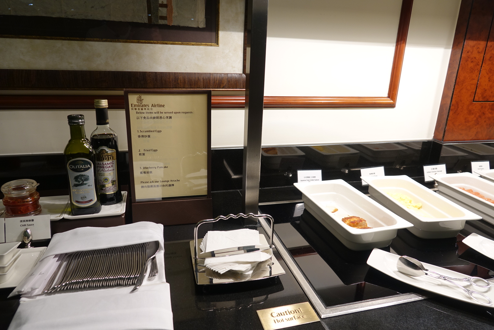 food in a buffet with a menu and bottles