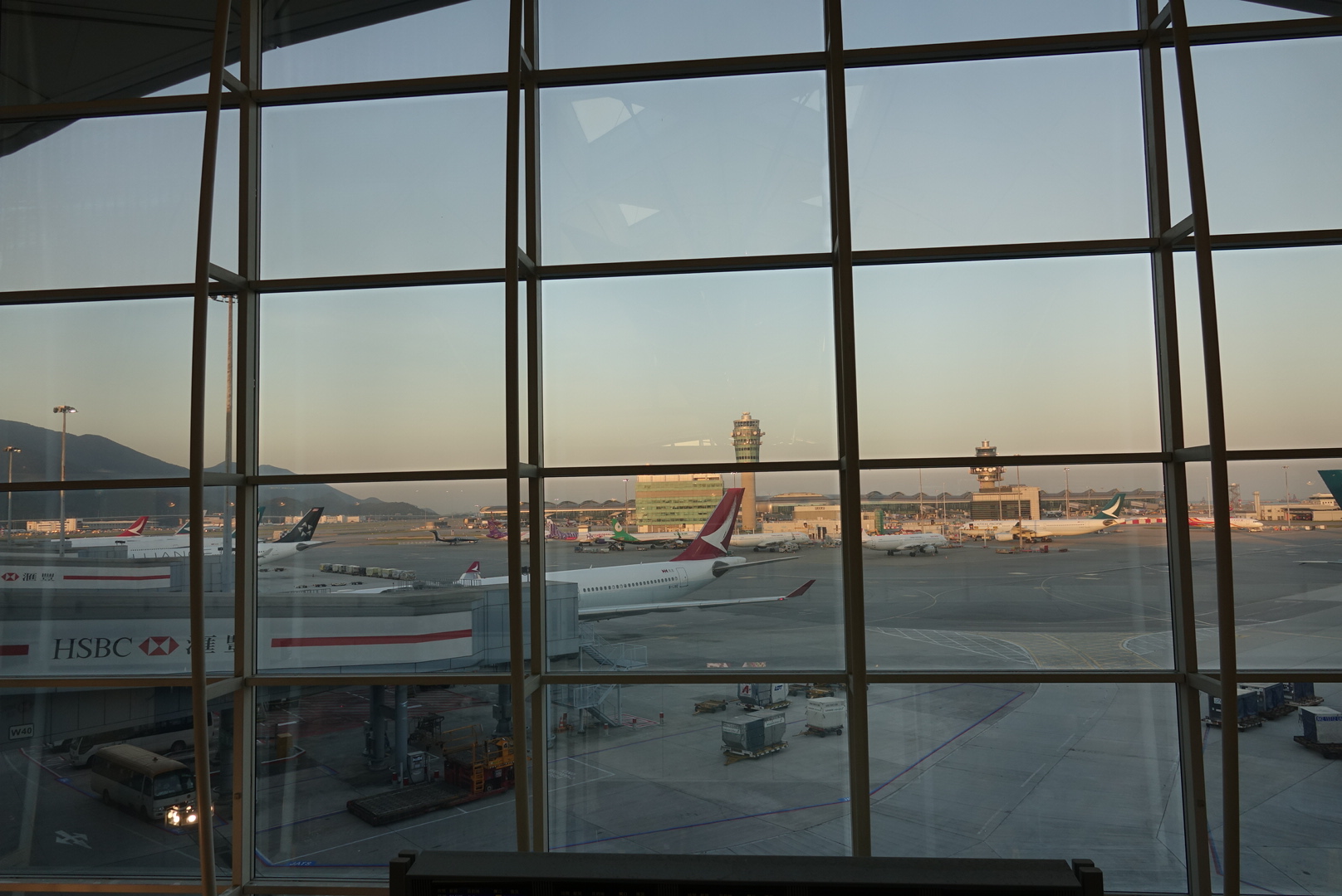 a window with many airplanes on the ground