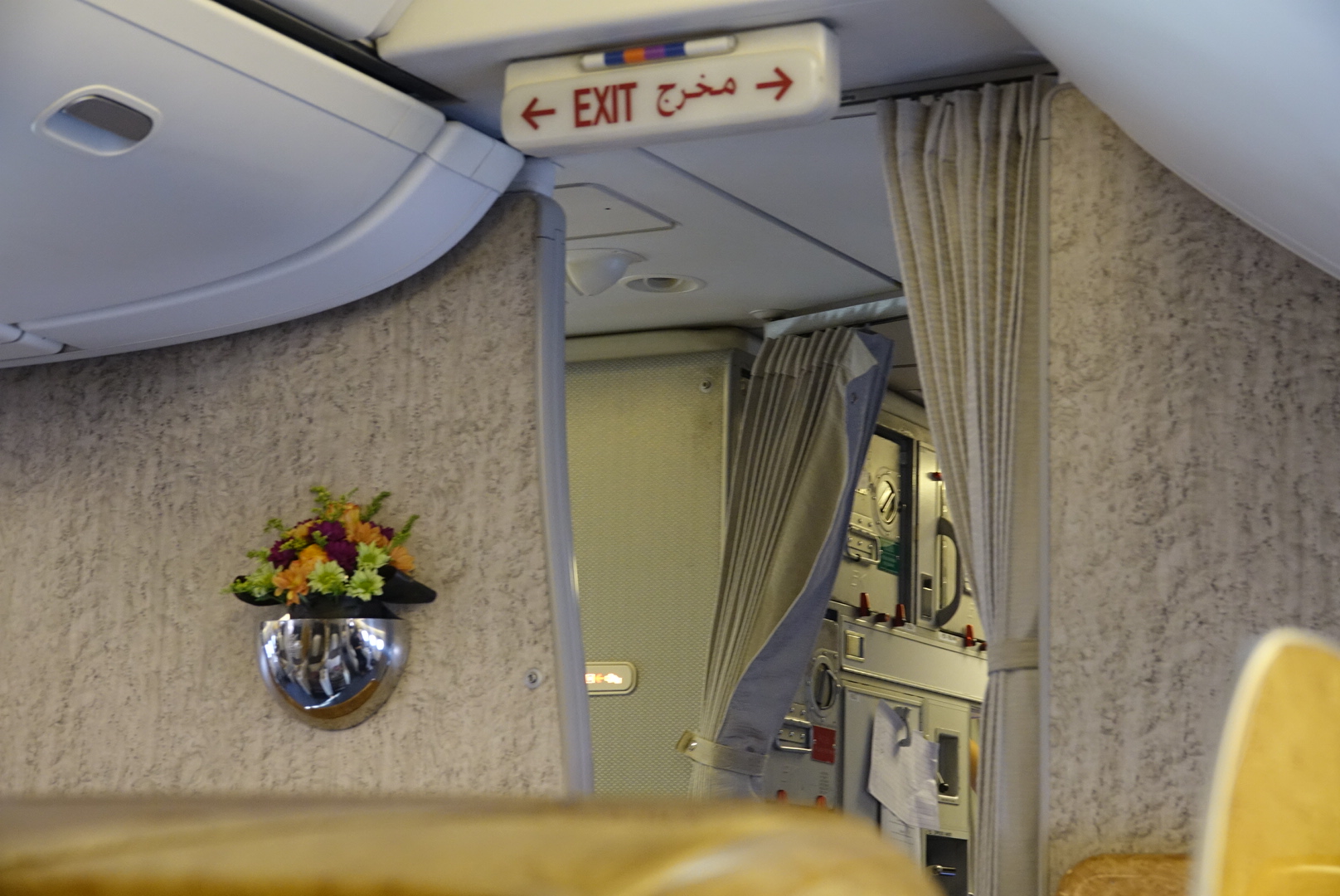 a mirror of an airplane with a sign and flowers