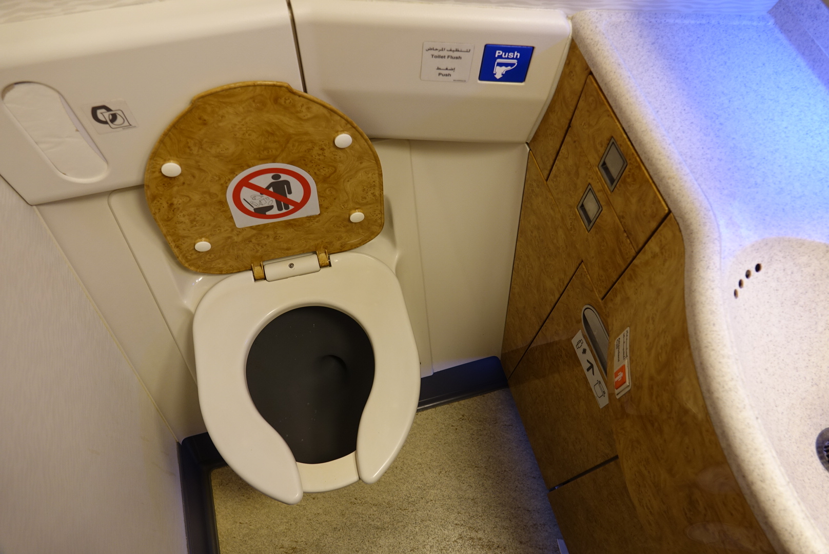 a toilet with a sign on the seat