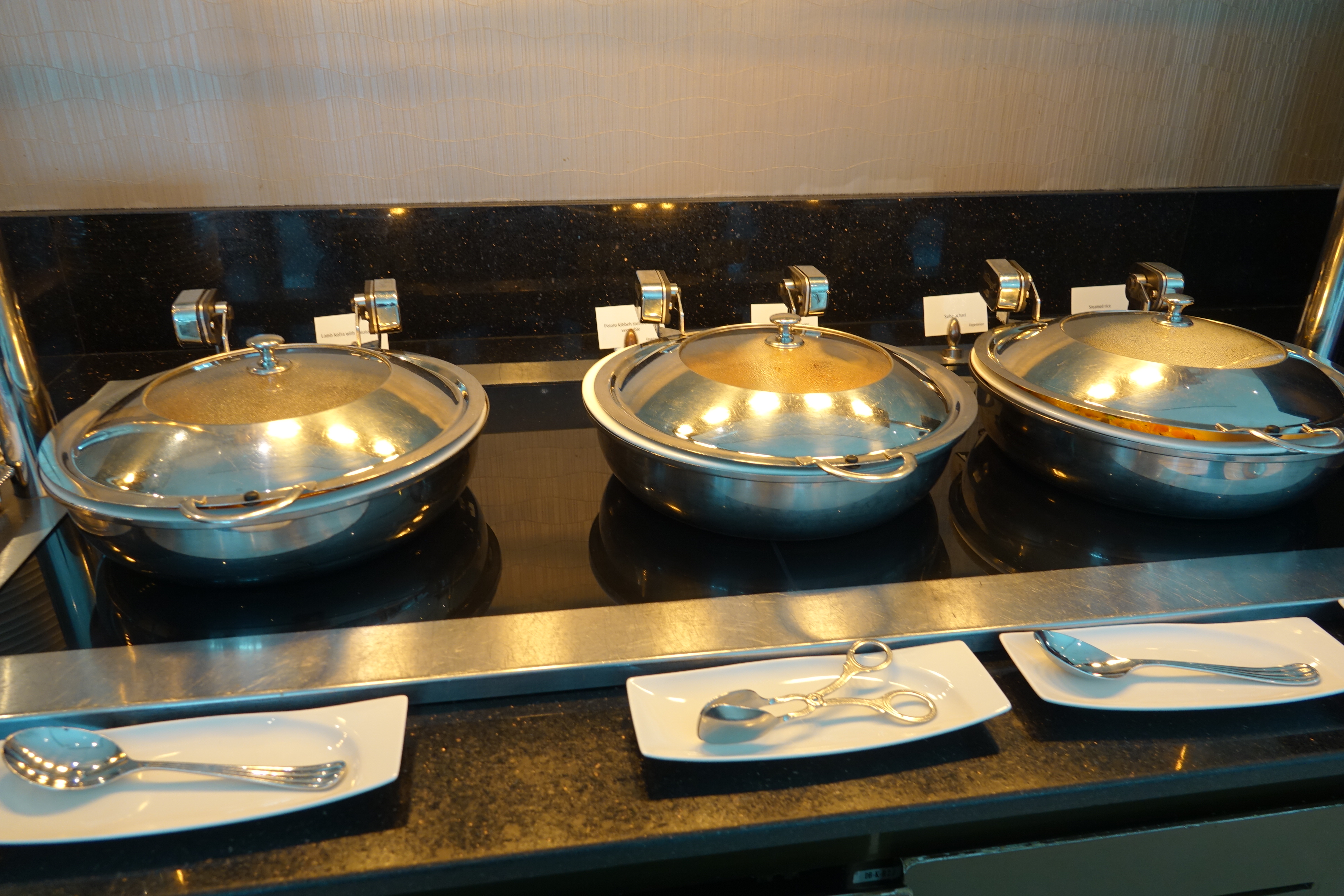 a row of silver pans on a counter