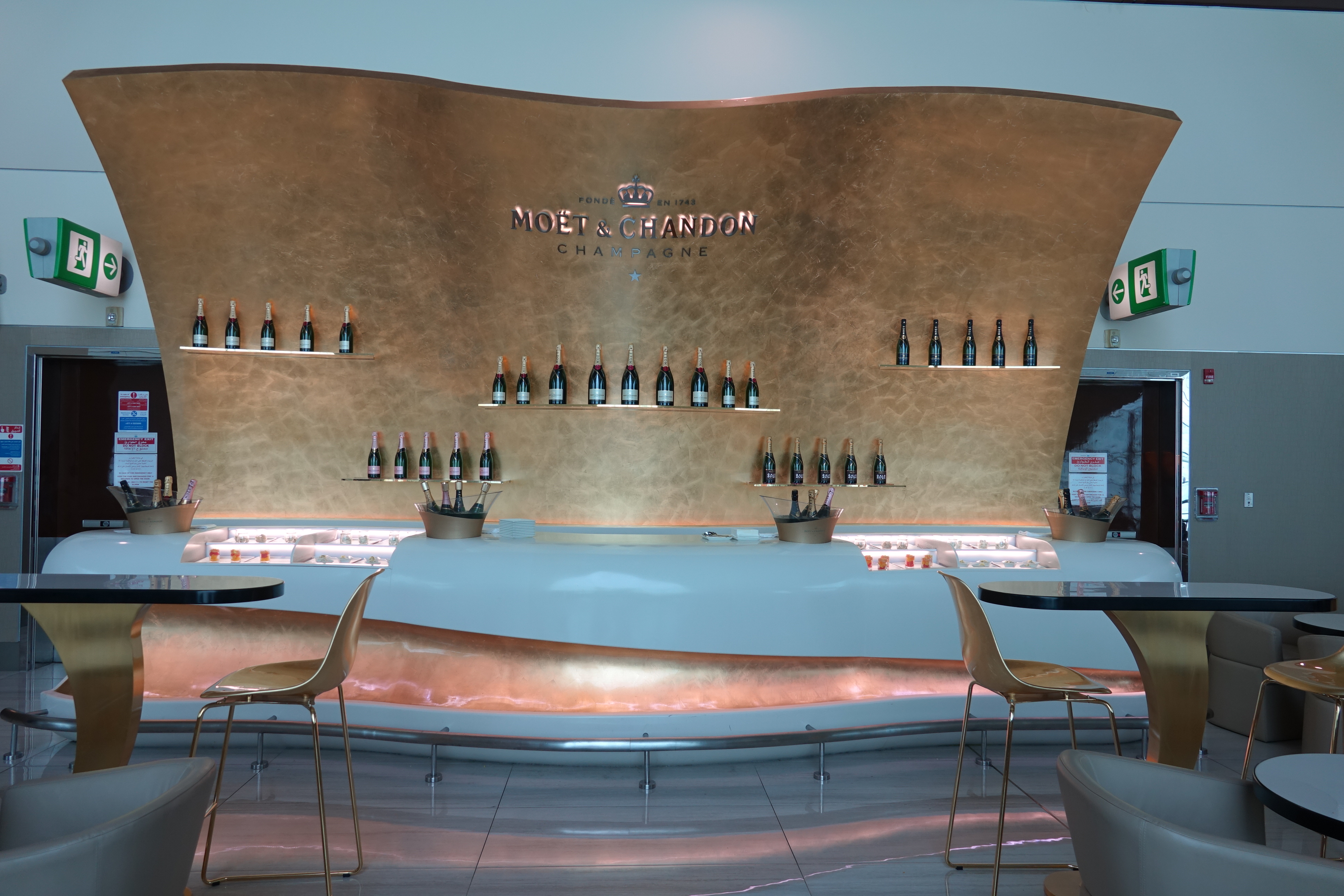 a bar with bottles of wine on the wall