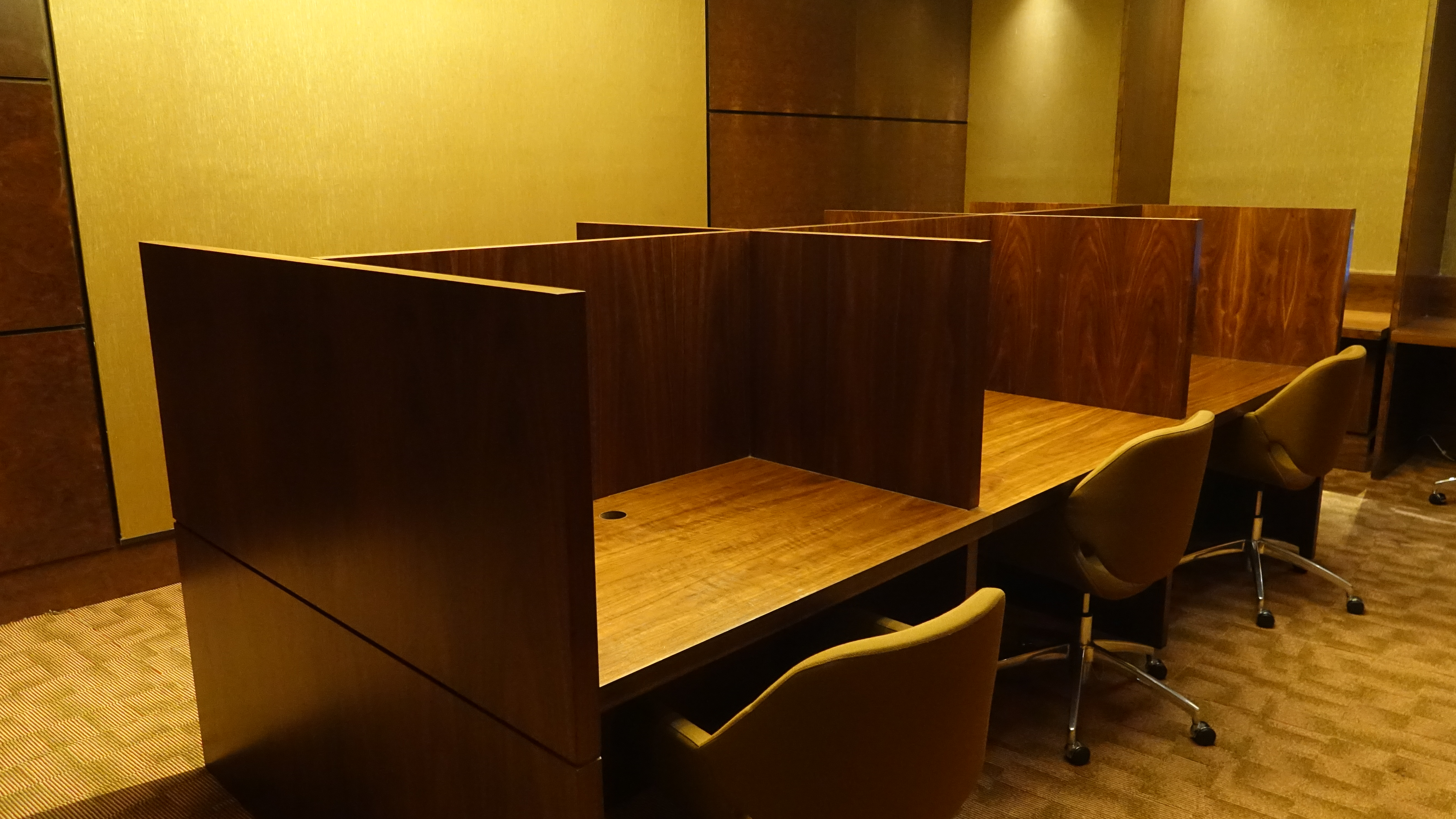 a desk with chairs and a few cubicles