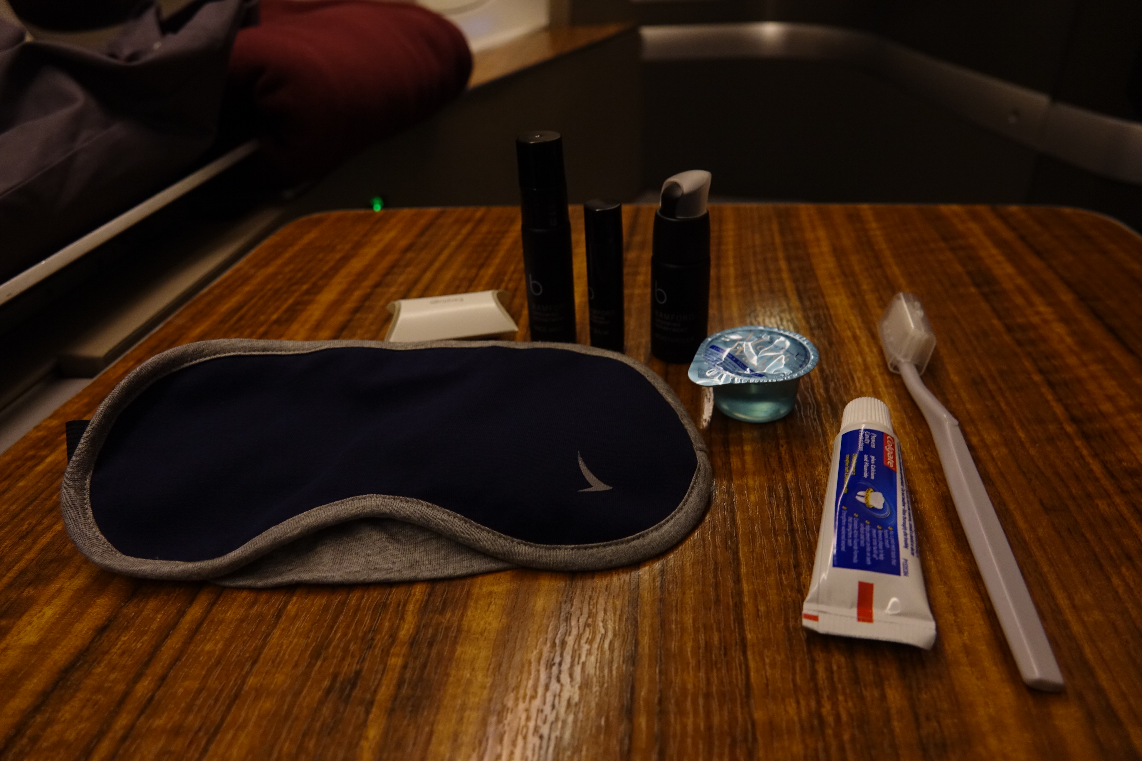 a sleeping bag and toothbrushes on a table