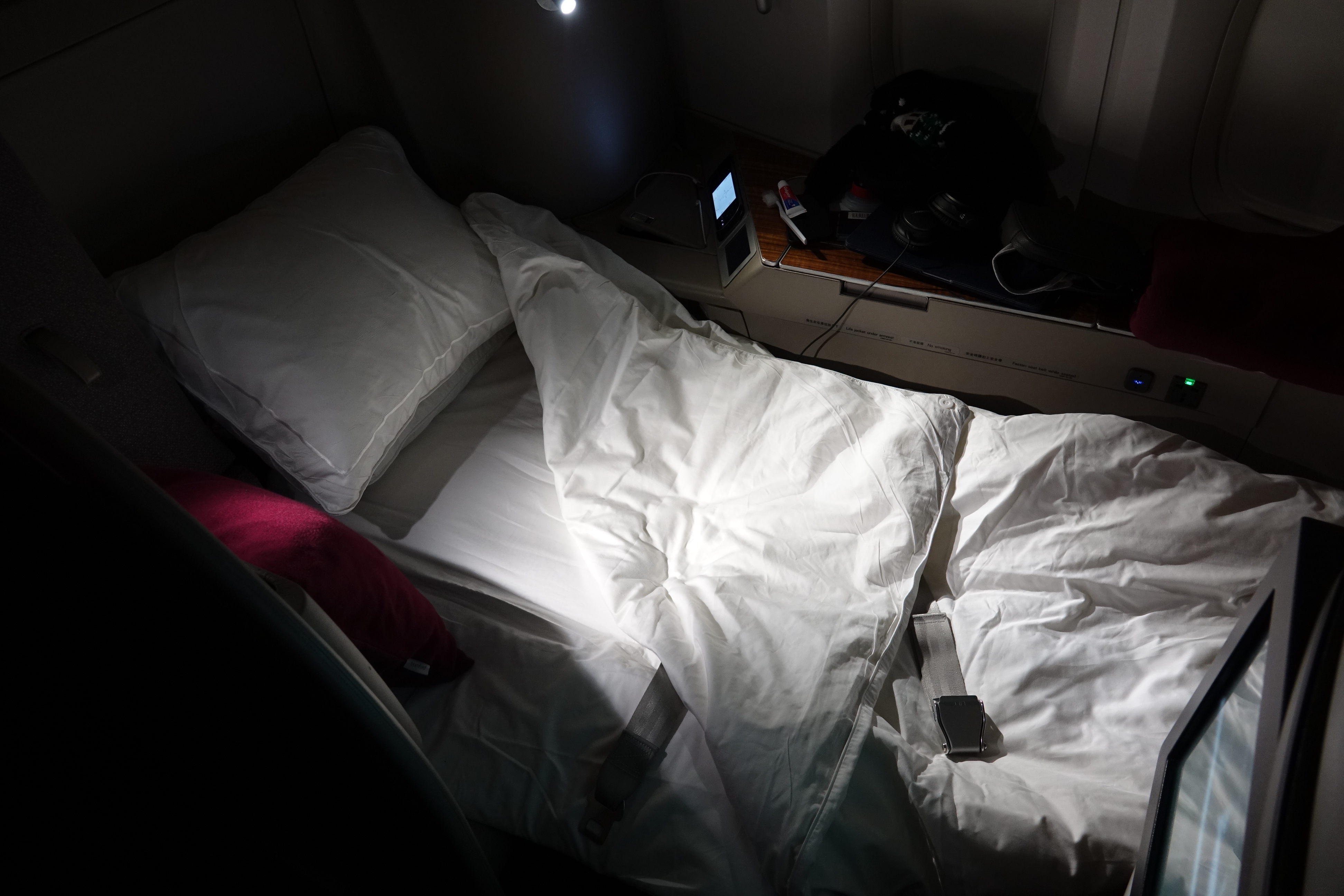 a bed with a pillow and a phone on it