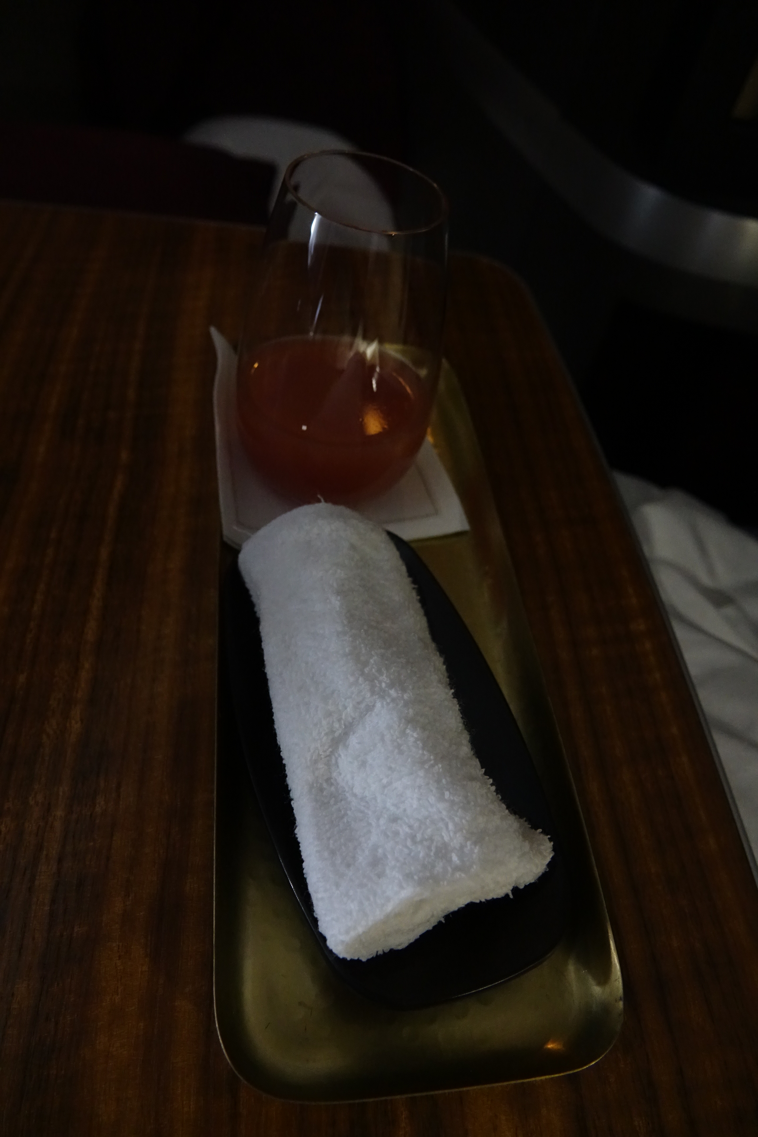 a towel and a glass of liquid on a tray