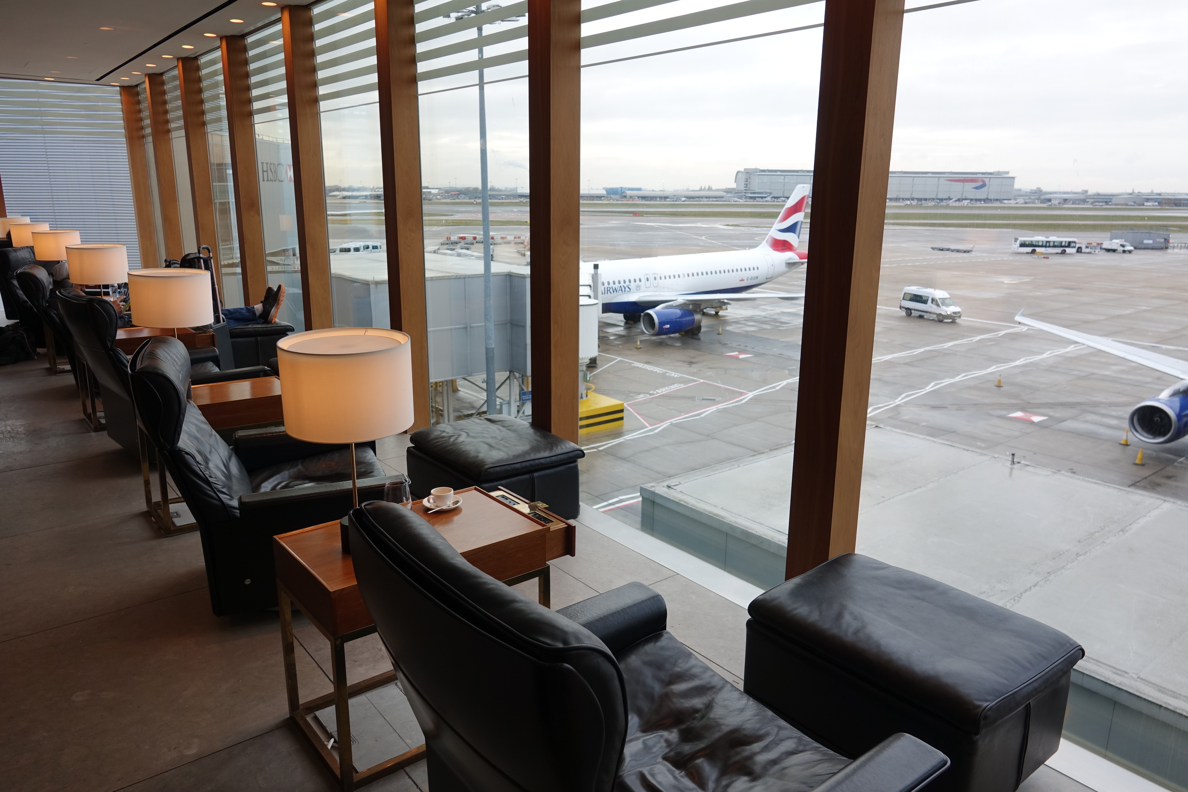 a room with a large window and a plane on the runway