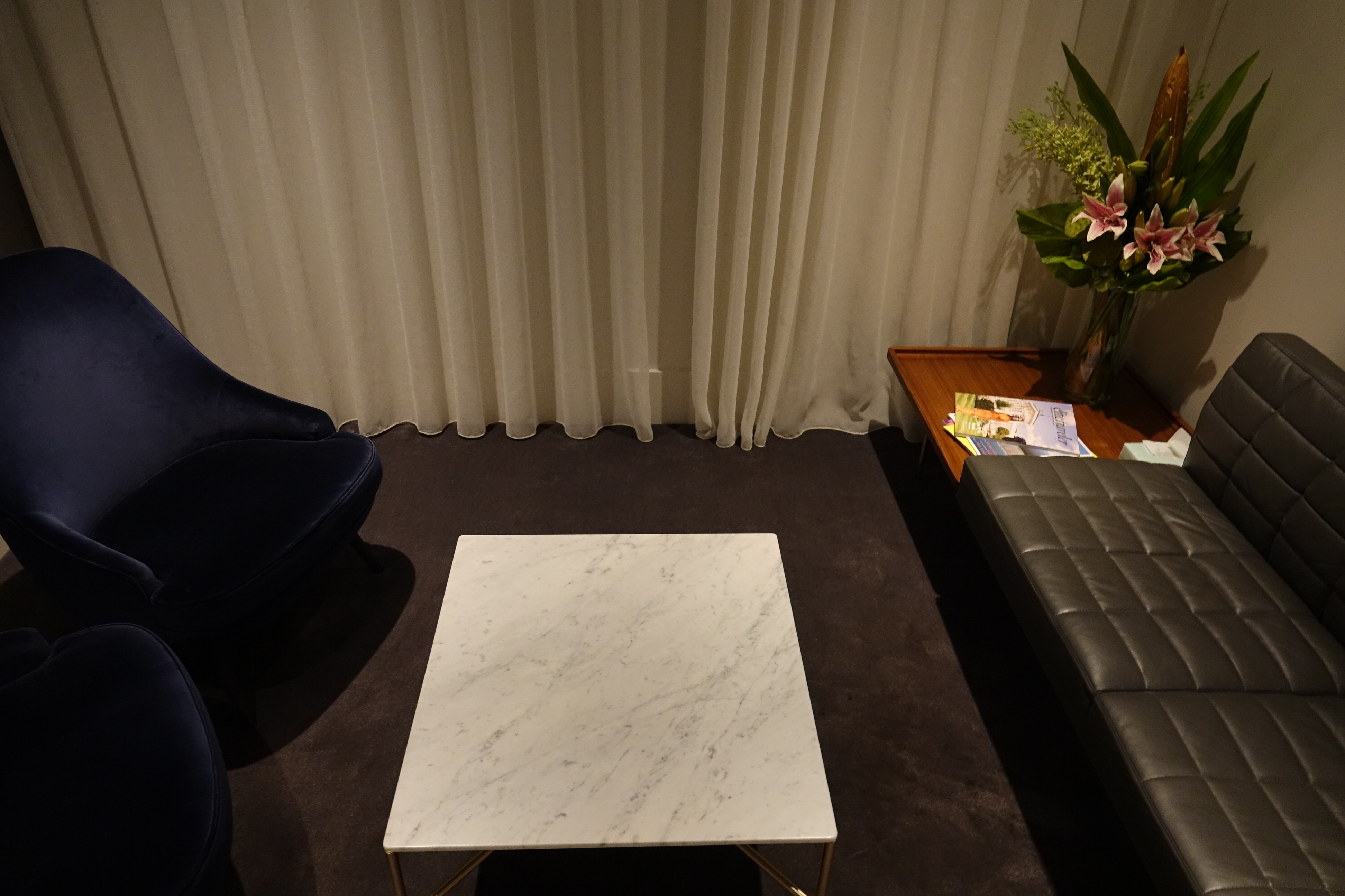 a white square table next to a couch