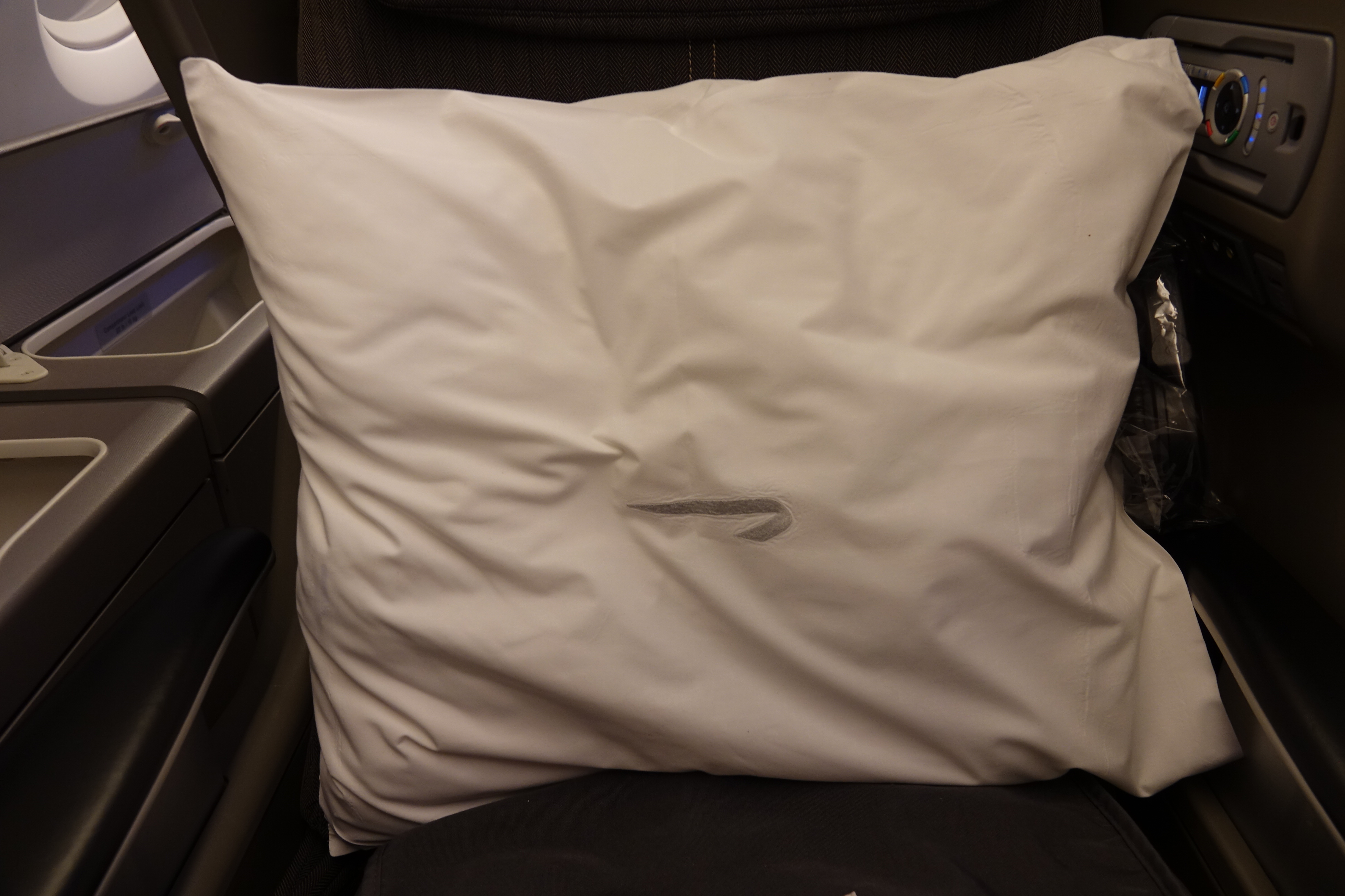 a white pillow on a chair