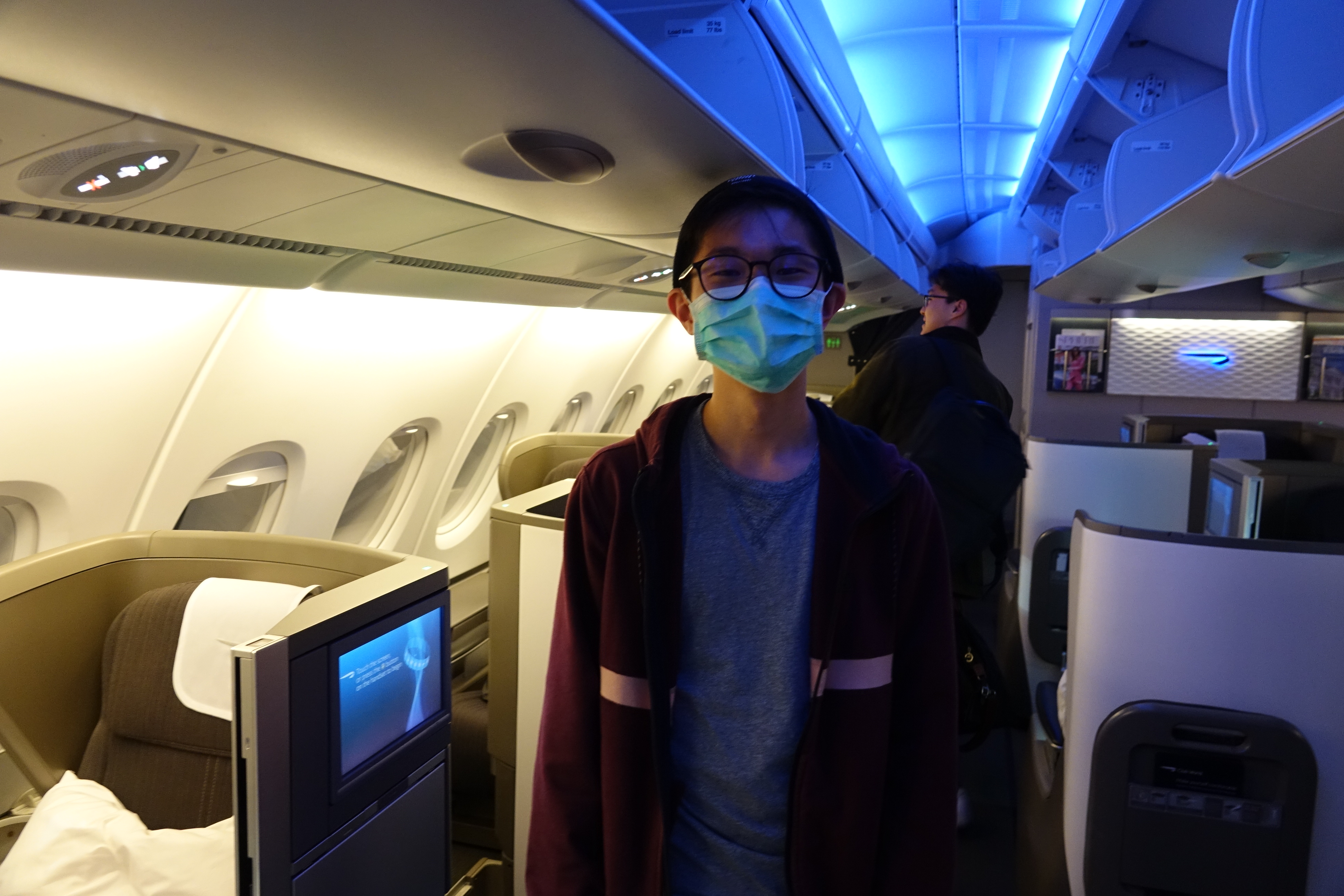 a boy wearing a mask on an airplane