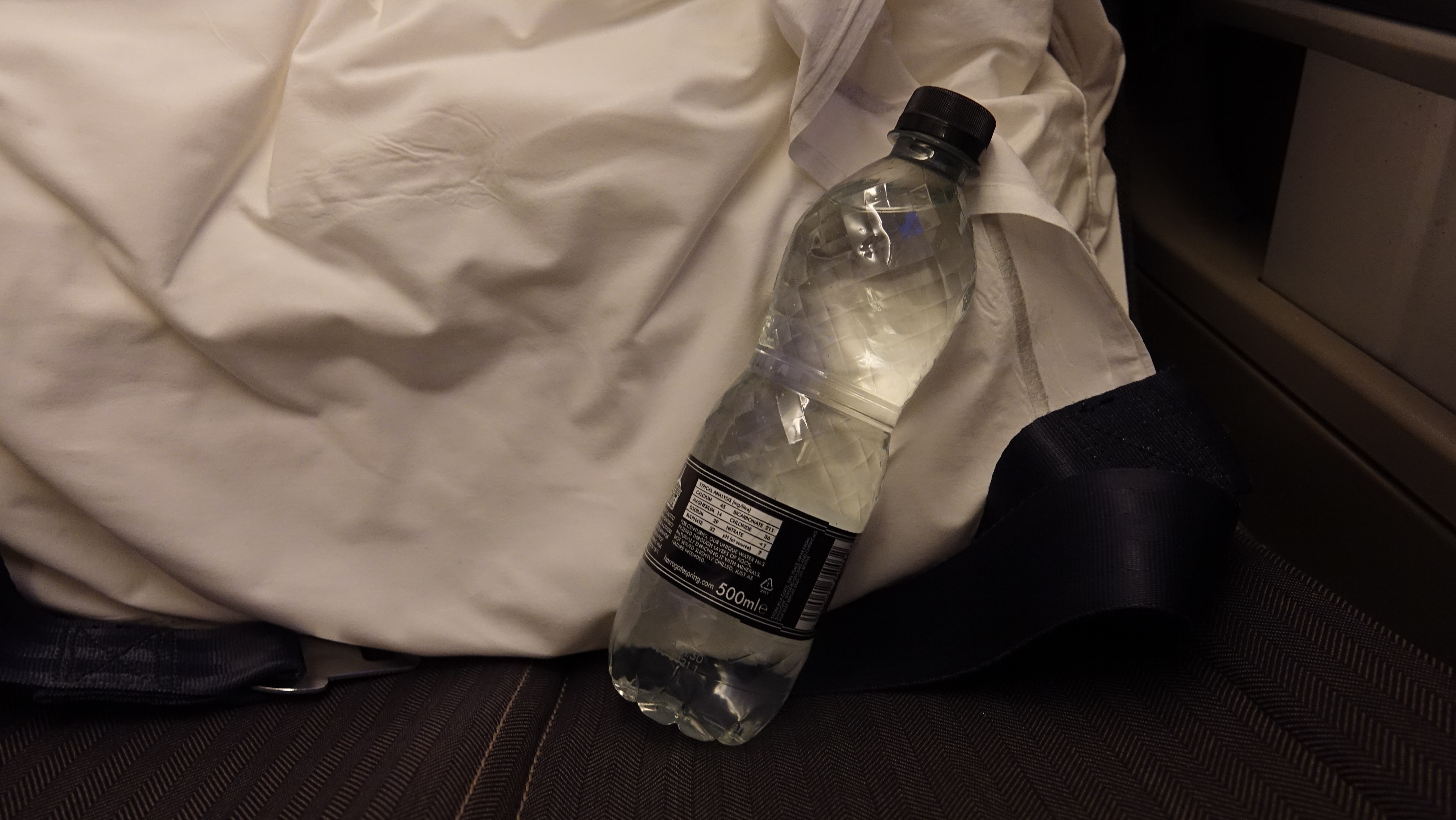 a bottle of water on a white cloth