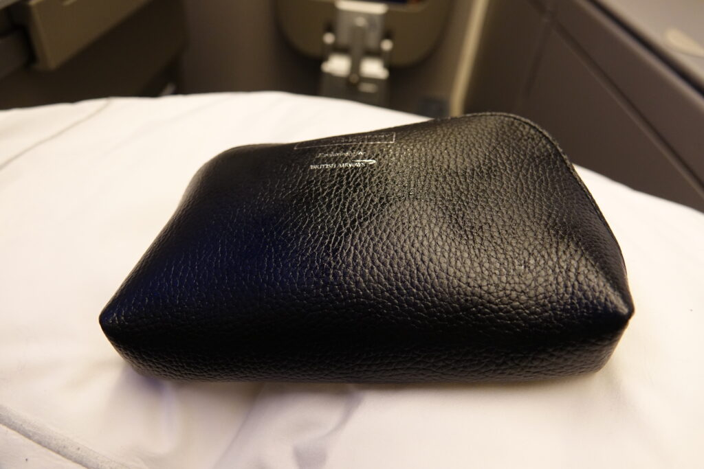a black leather pouch on a white sheet