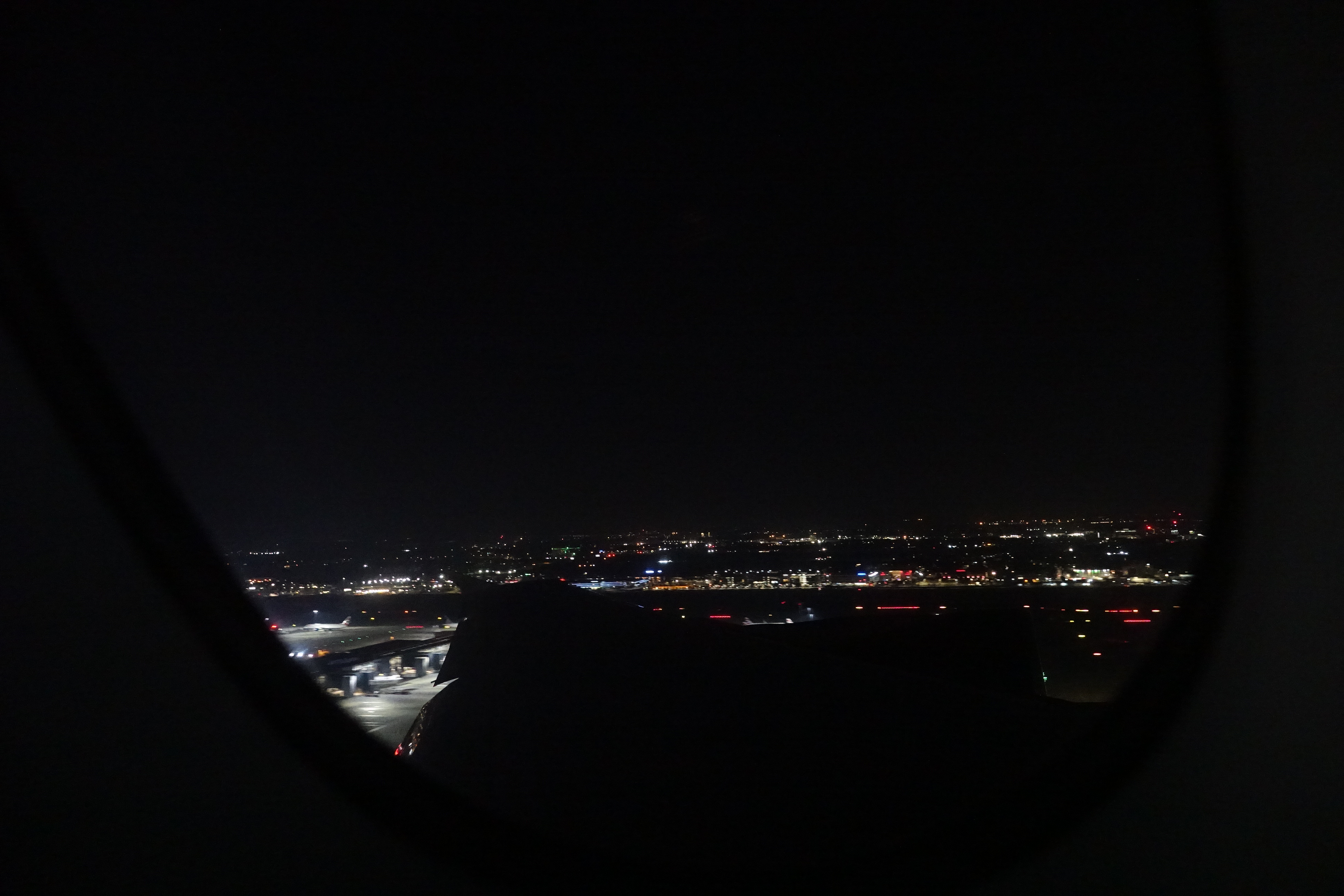 a view of a city at night from a plane window