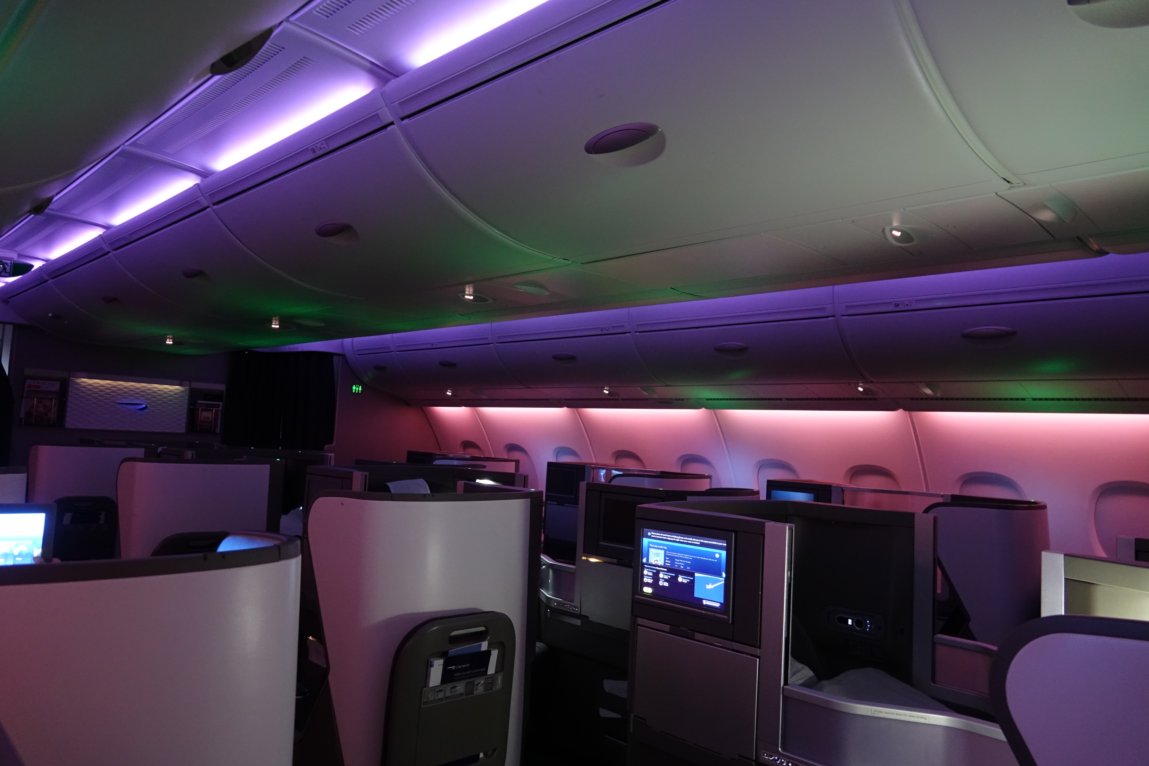 an airplane with a purple and green light
