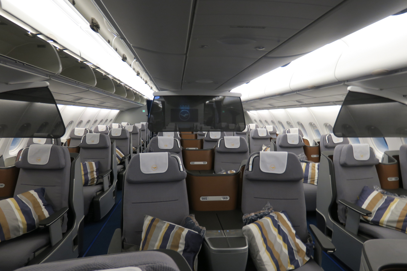 the inside of an airplane with seats and a television