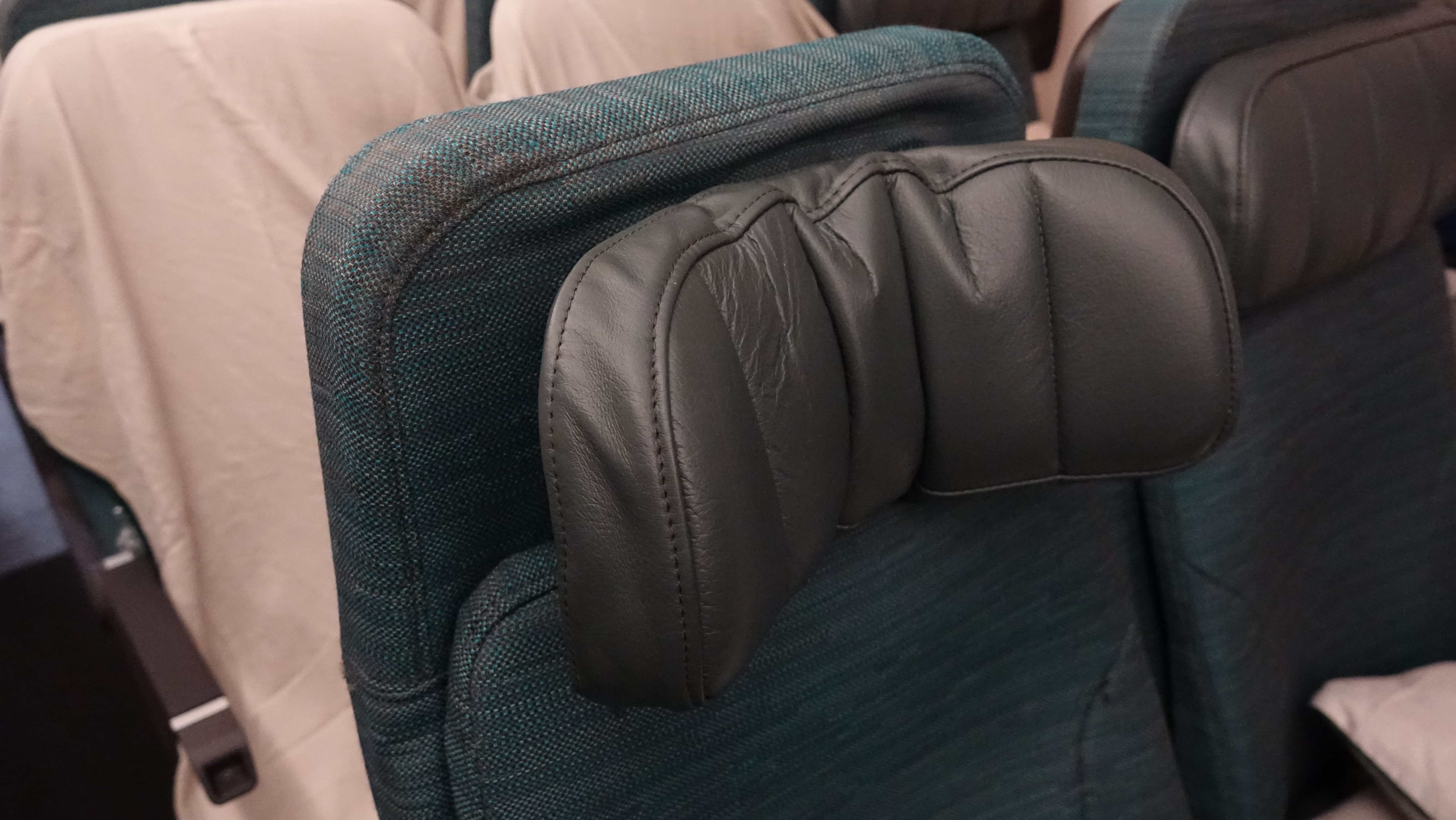 a black leather head rest on a chair