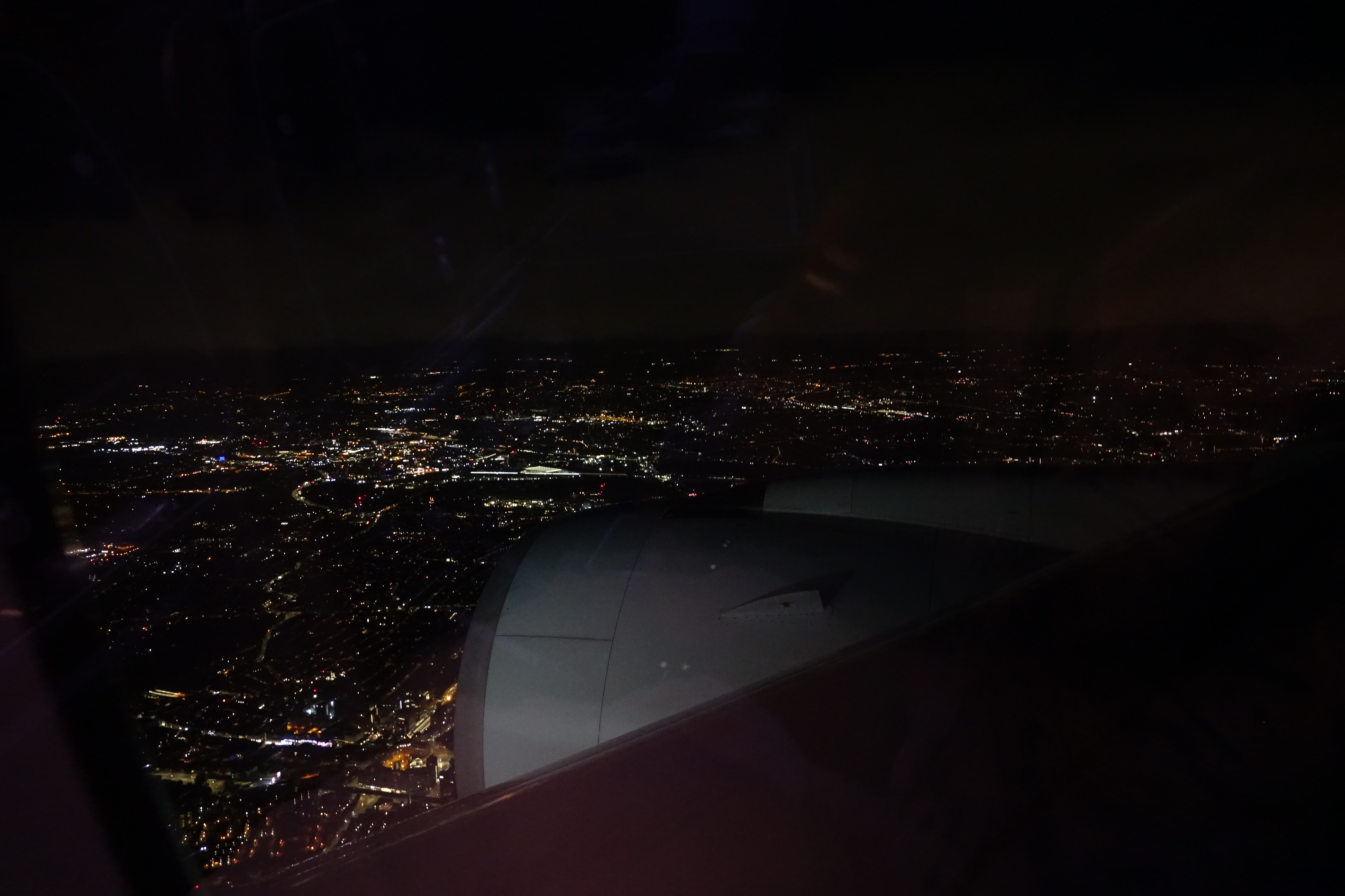 a view of a city from an airplane window at night