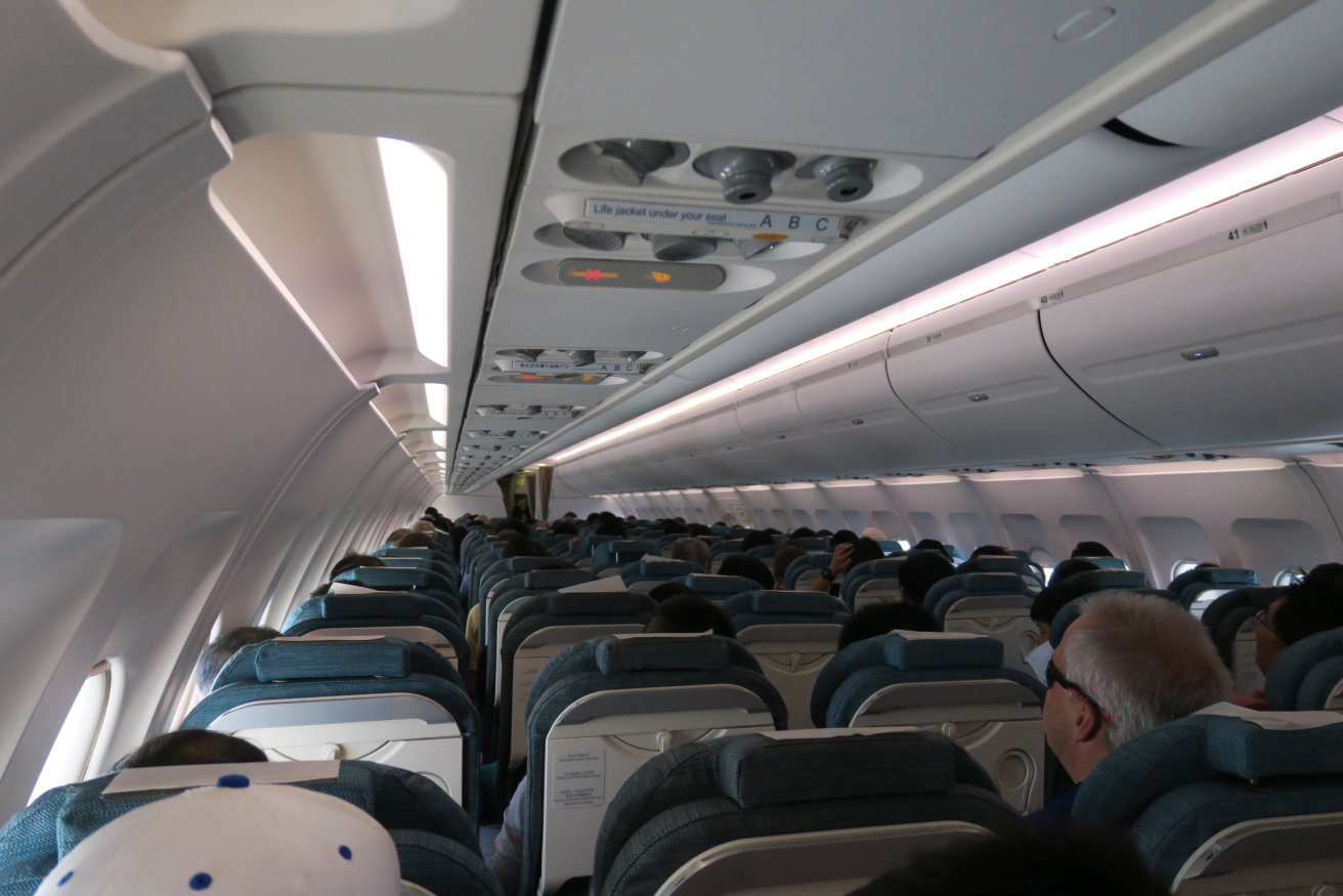 a plane with many seats and a few people