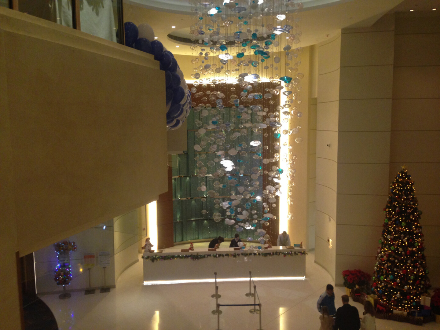 a lobby with a large chandelier and balloons