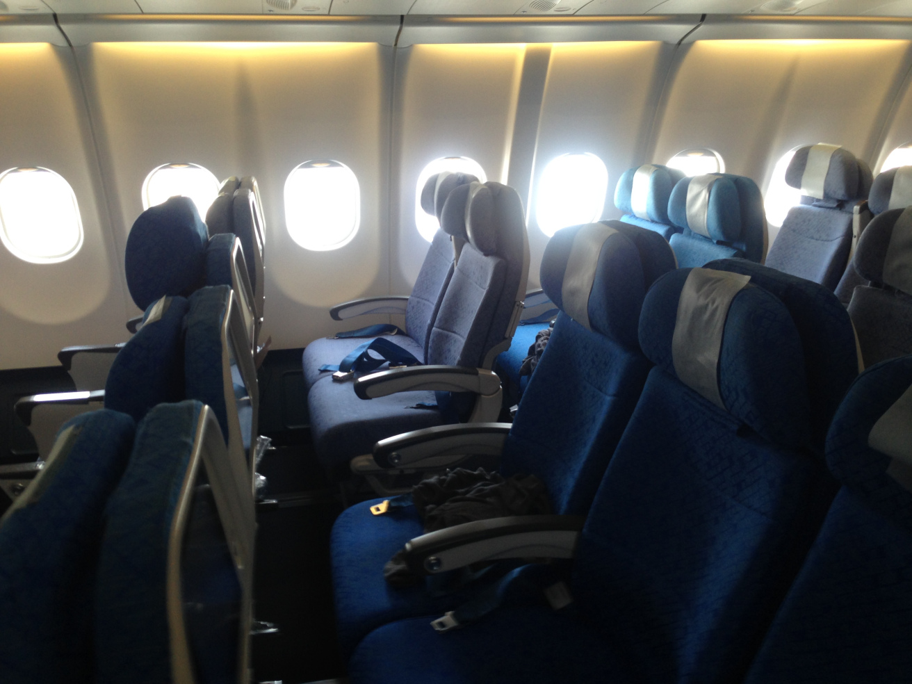 a row of blue seats on an airplane