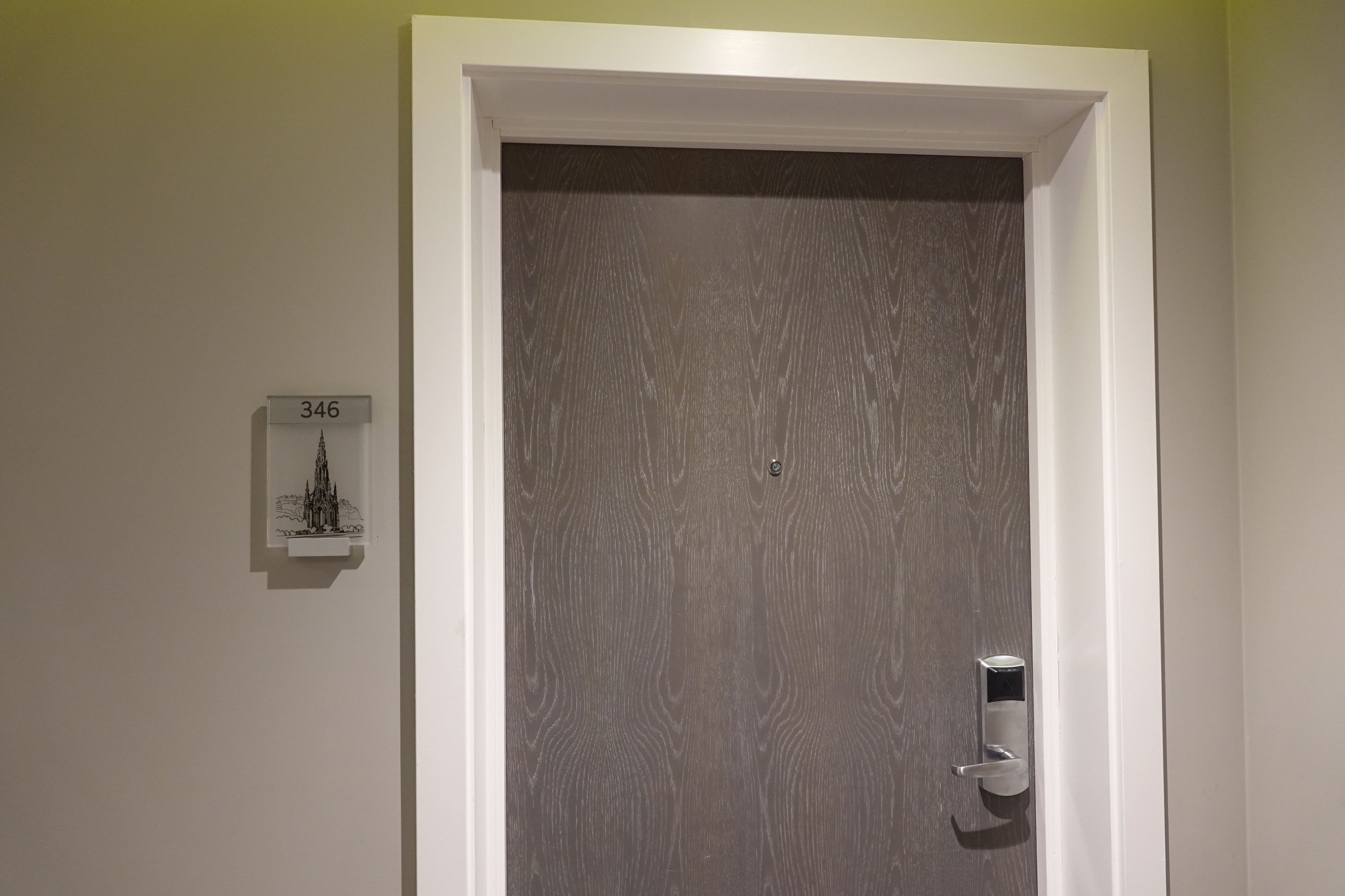 a door with a doorknob and a sign