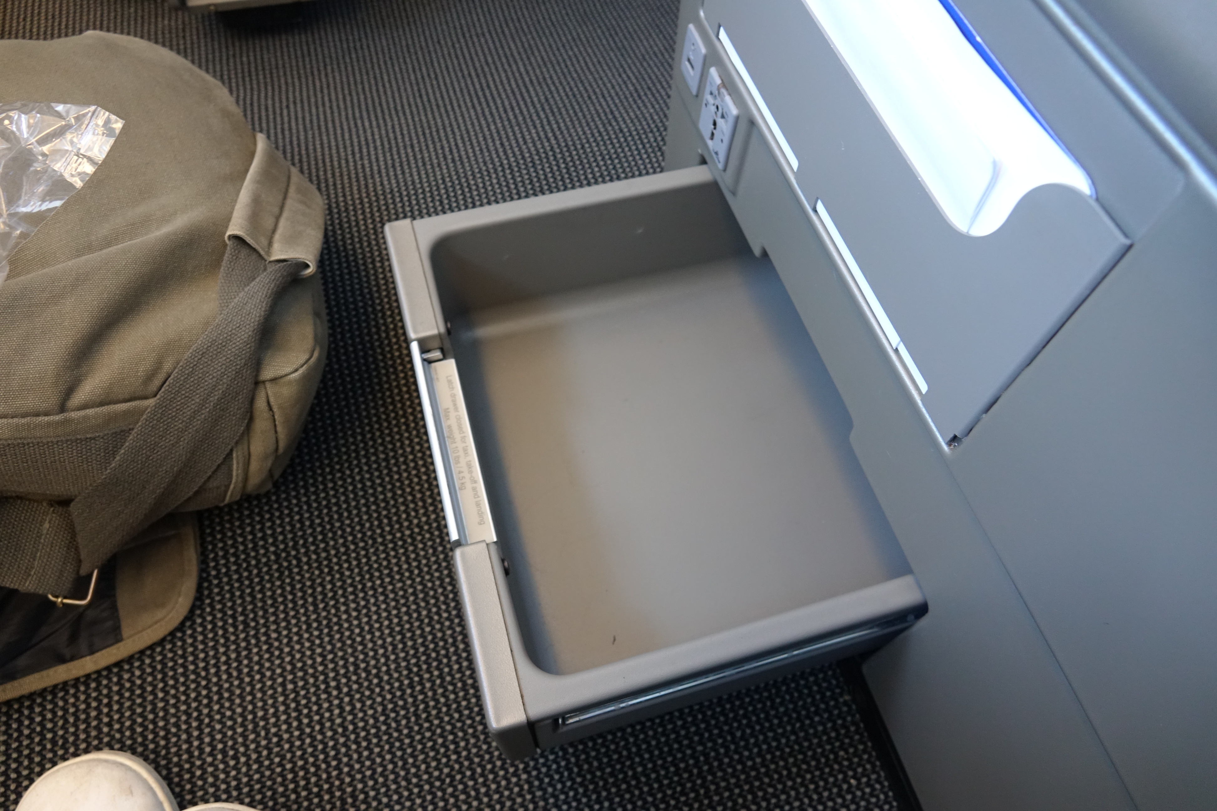 an empty drawer in an airplane