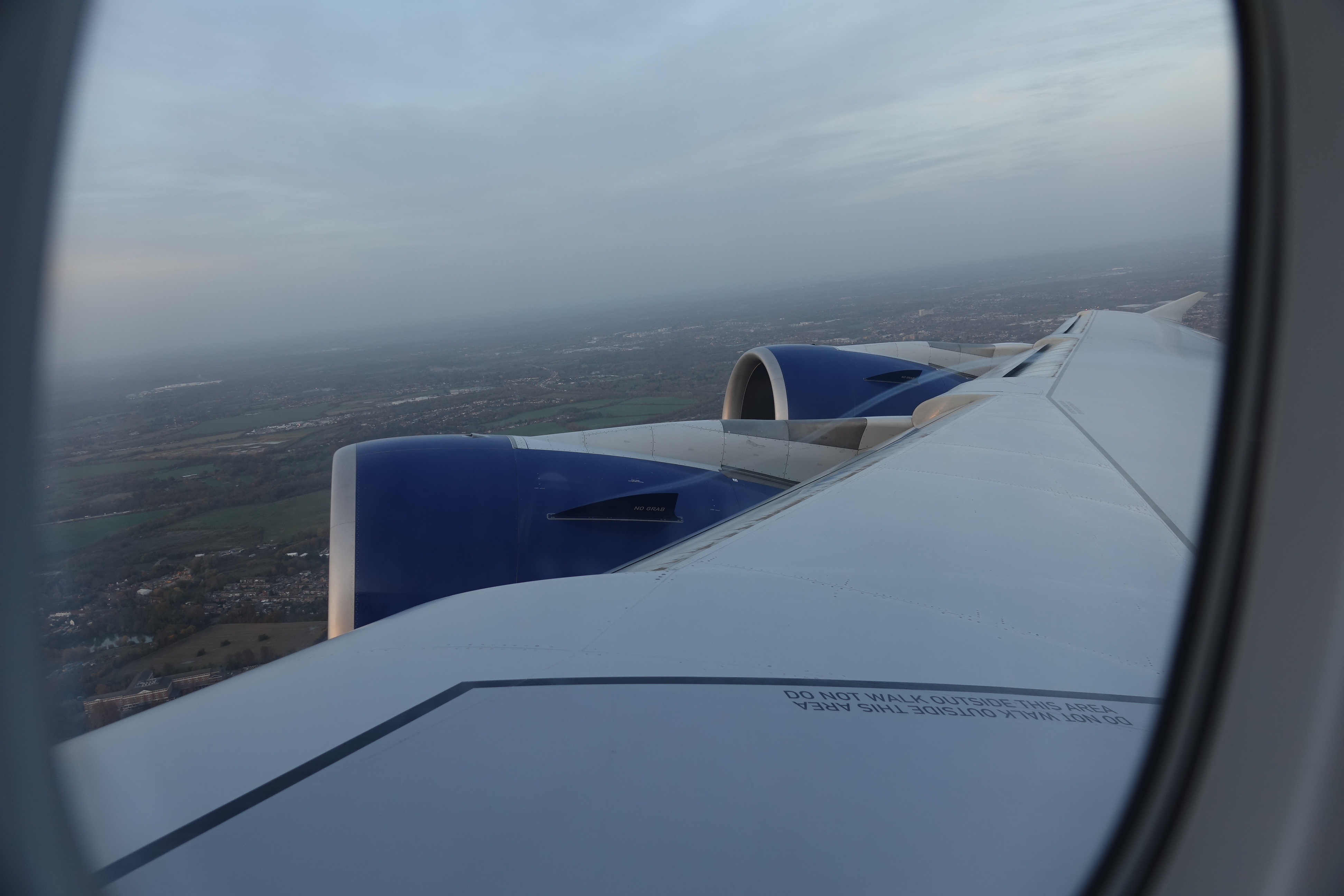 an airplane wing with blue and white engines