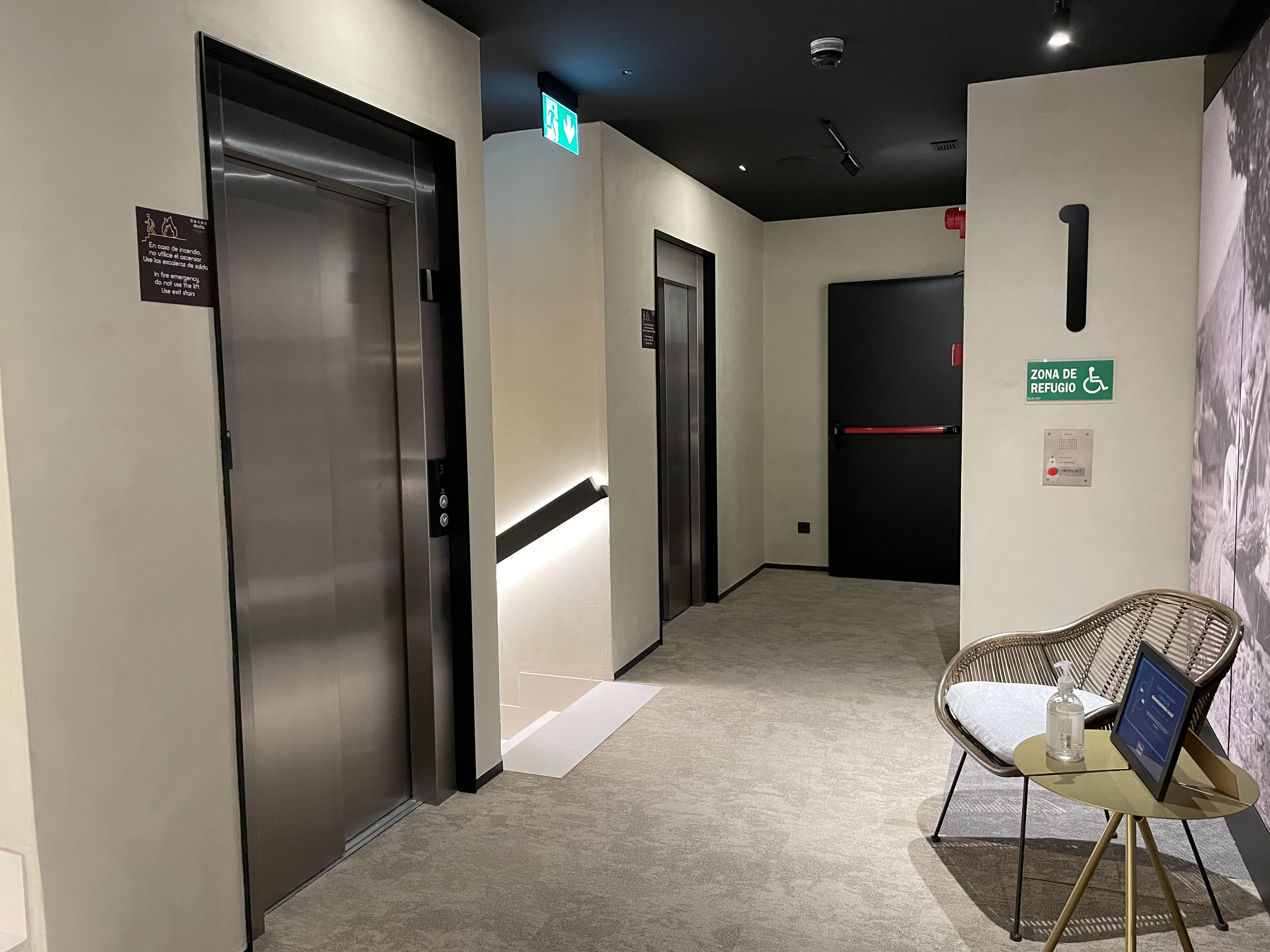 a room with two elevators and a chair