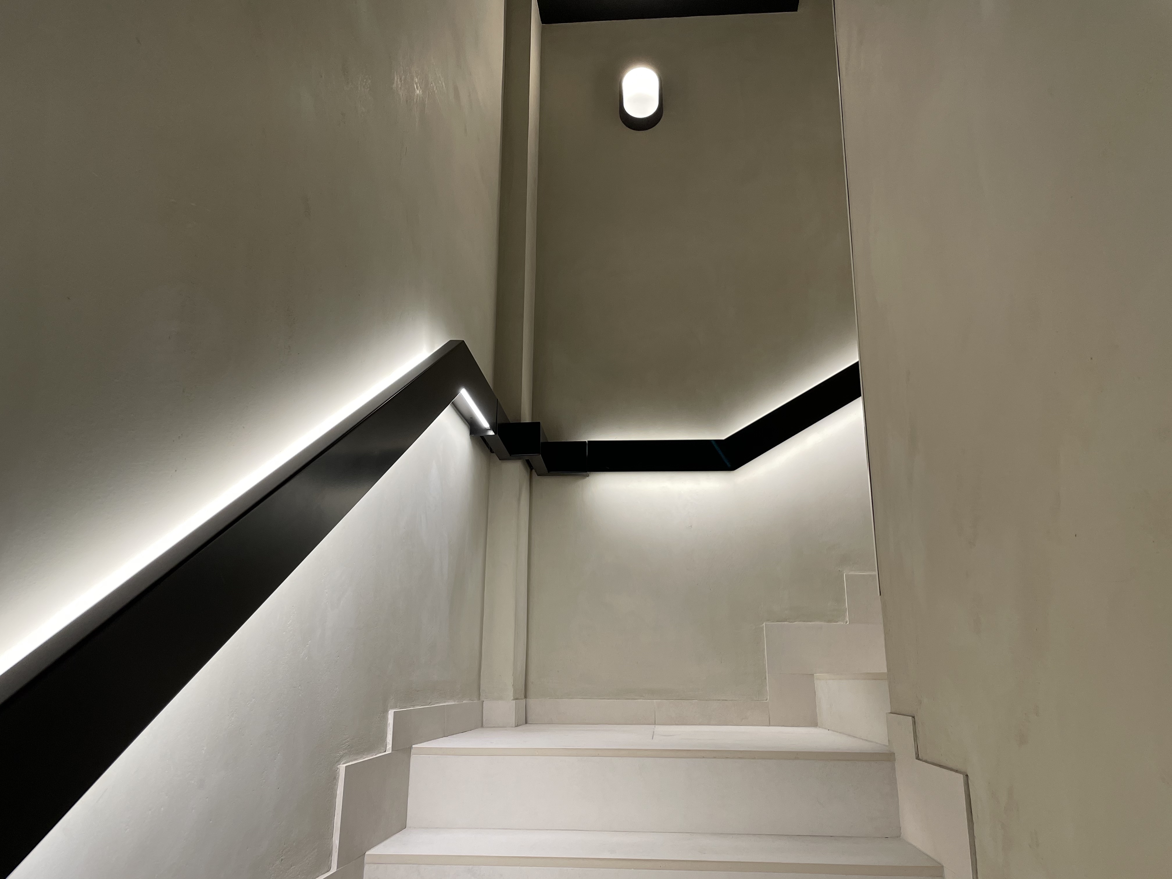 a white staircase with black railings