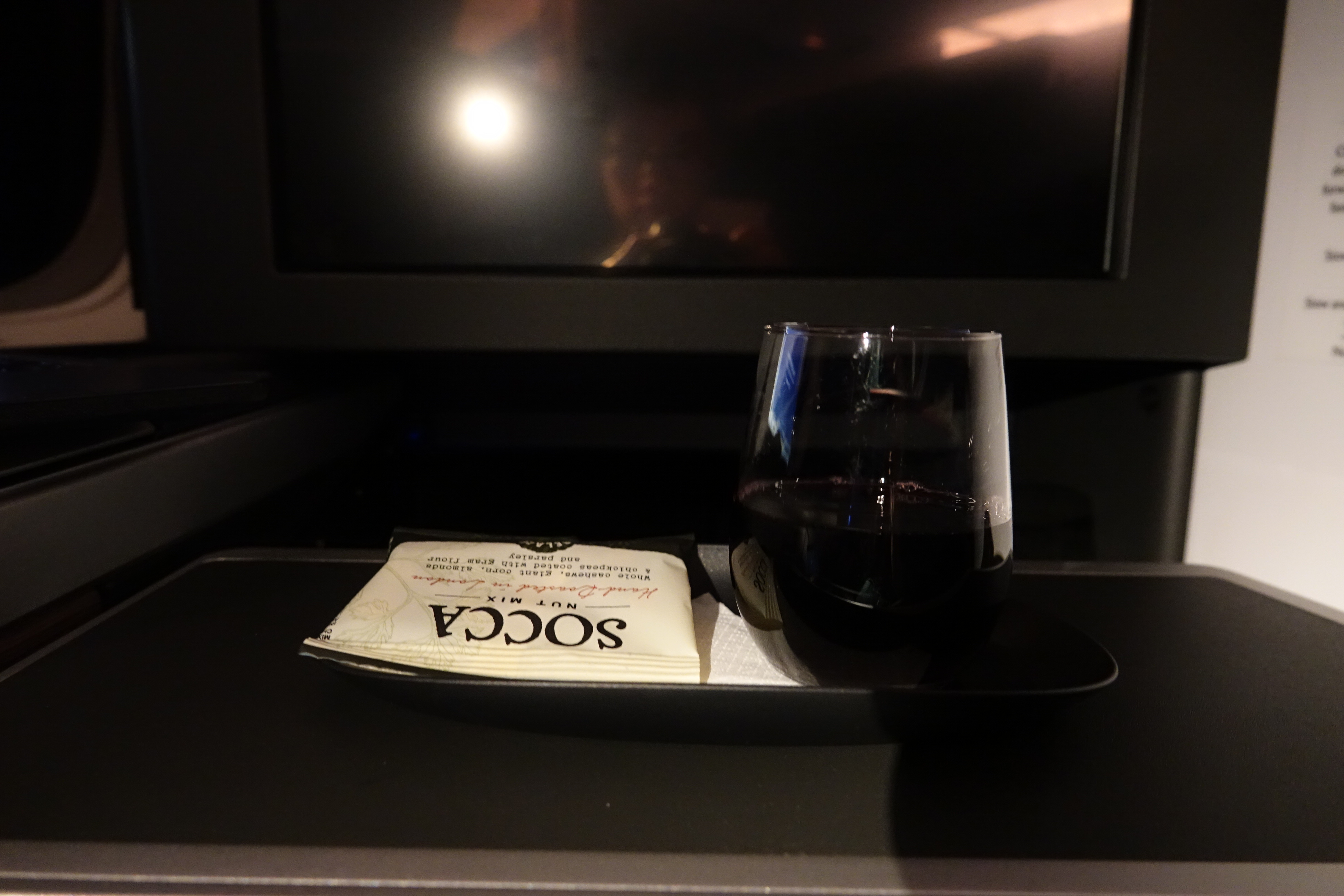 a glass of wine and napkins on a tray