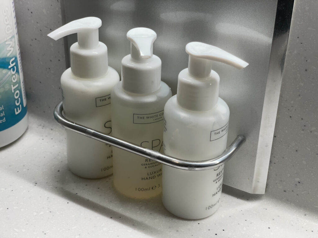 a group of white bottles on a metal holder