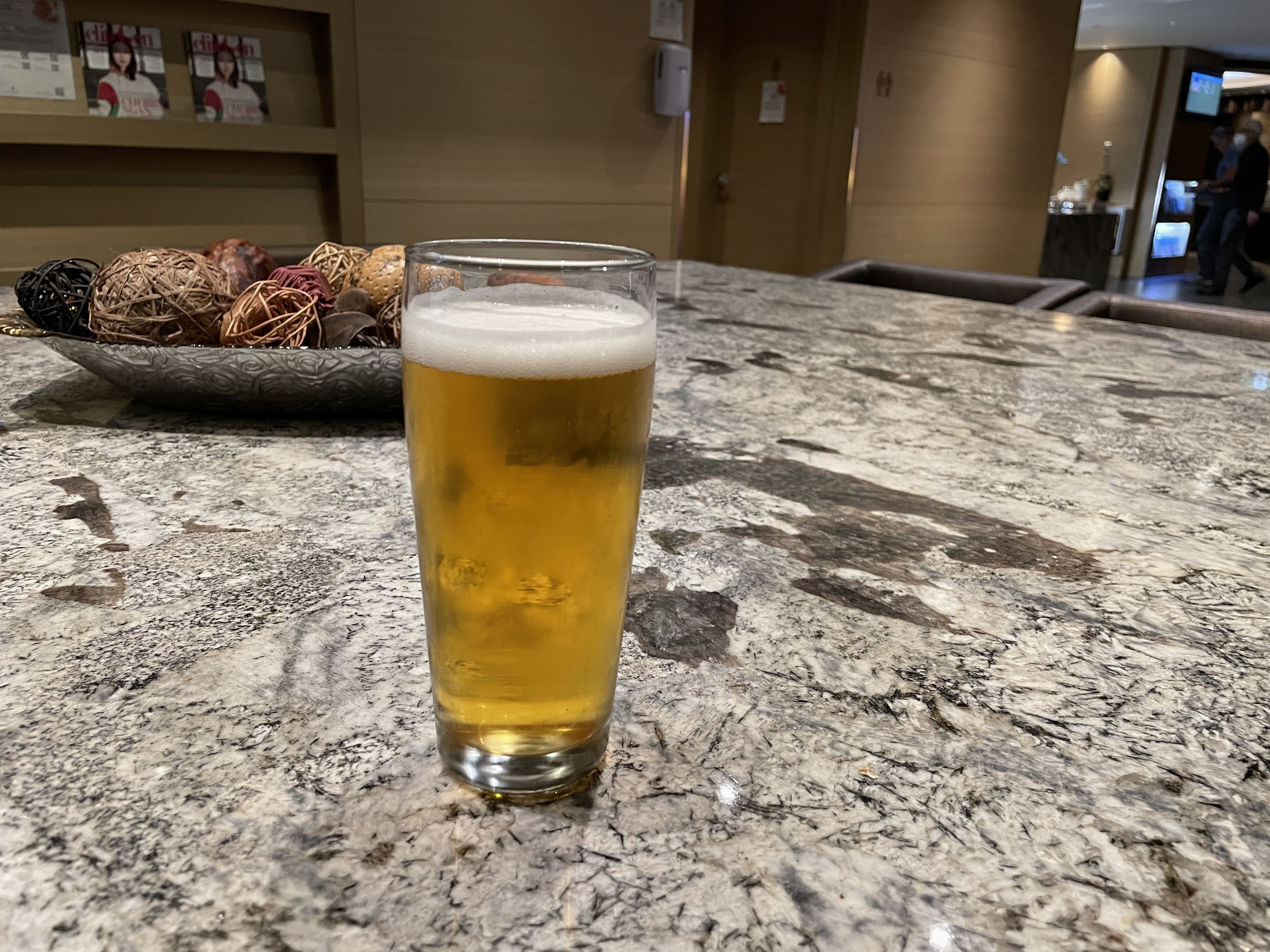 a glass of beer on a marble table
