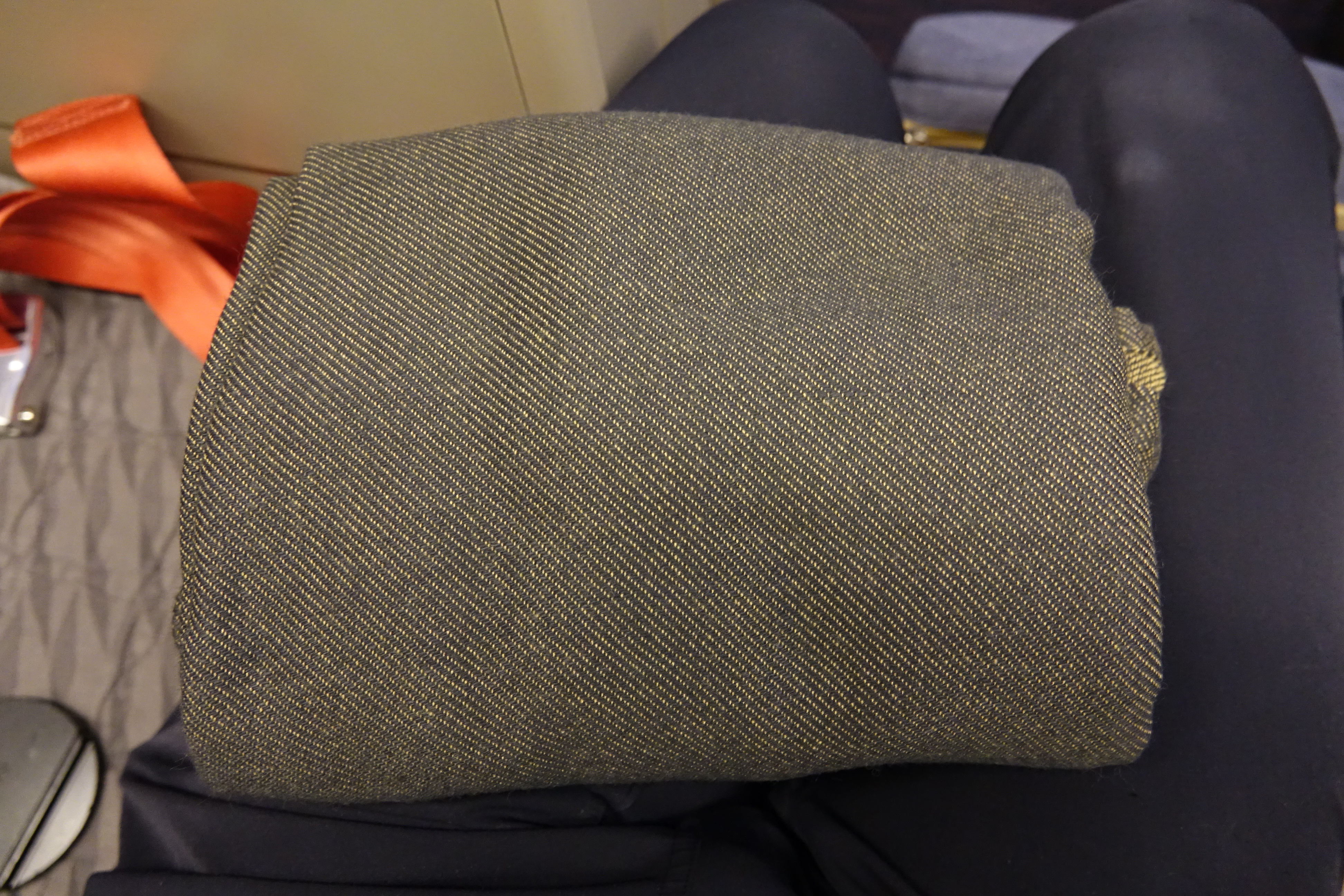 a rolled up fabric on a person's lap