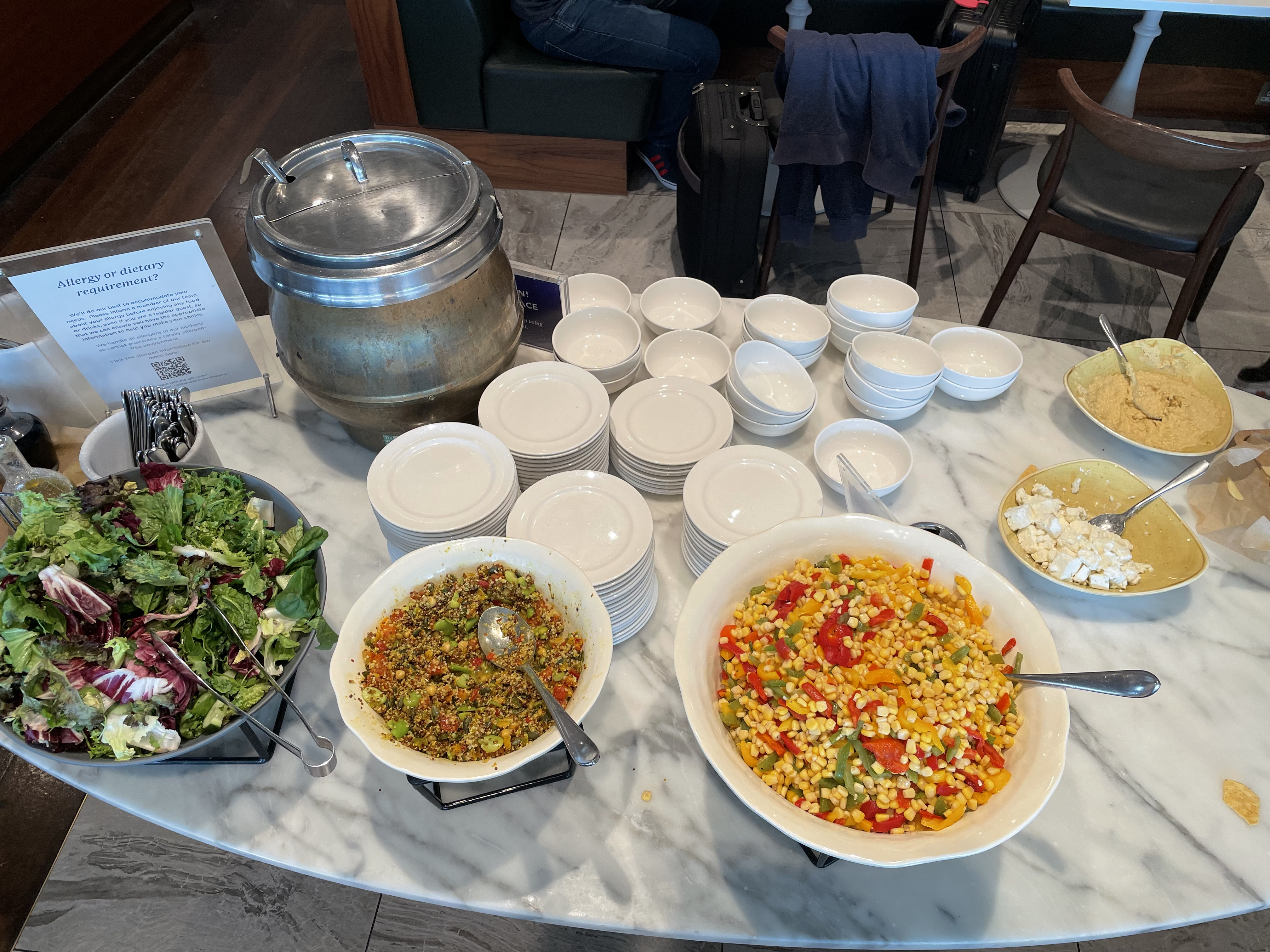 a table with bowls of food and plates