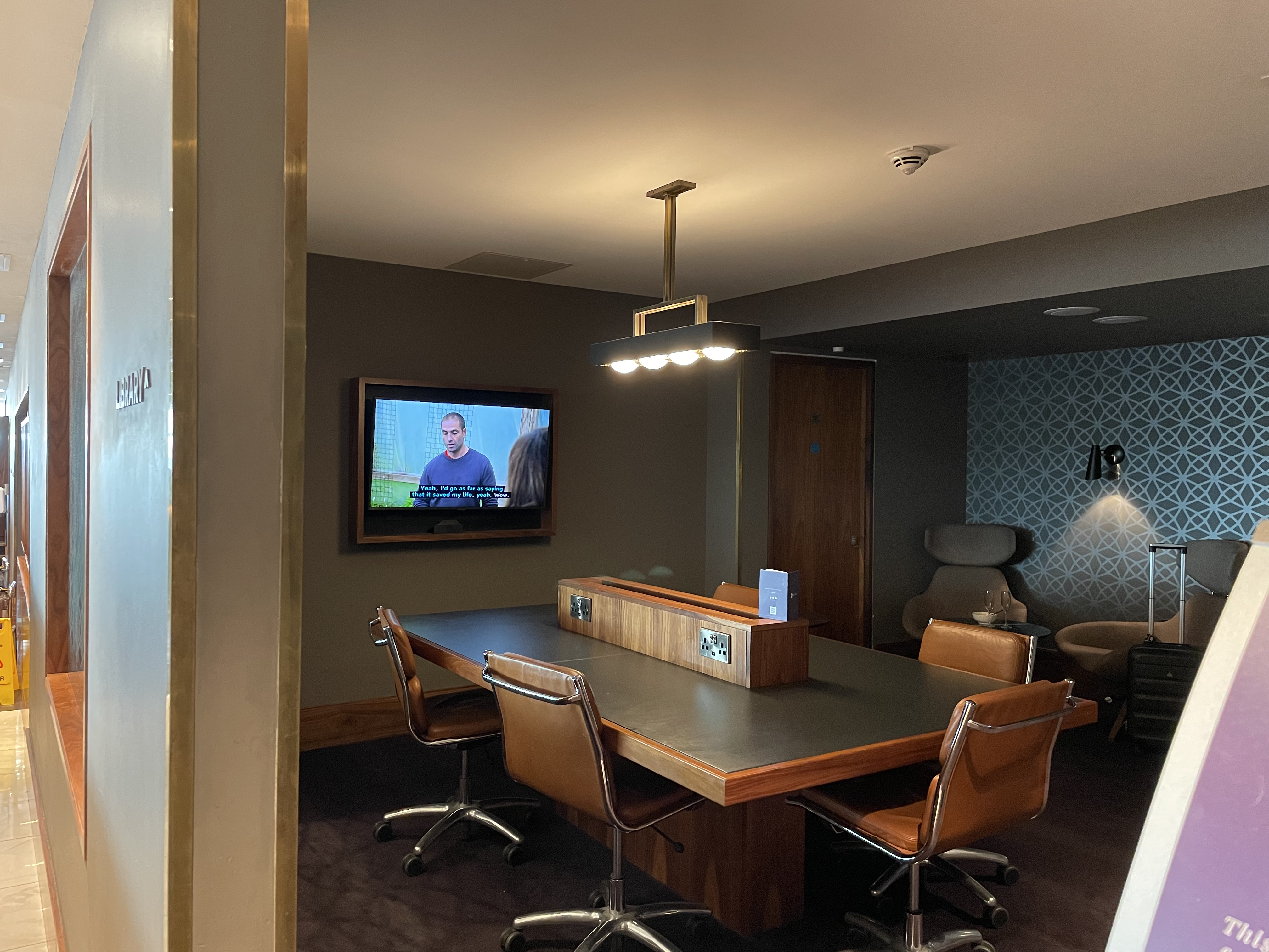 a conference room with a television and a table