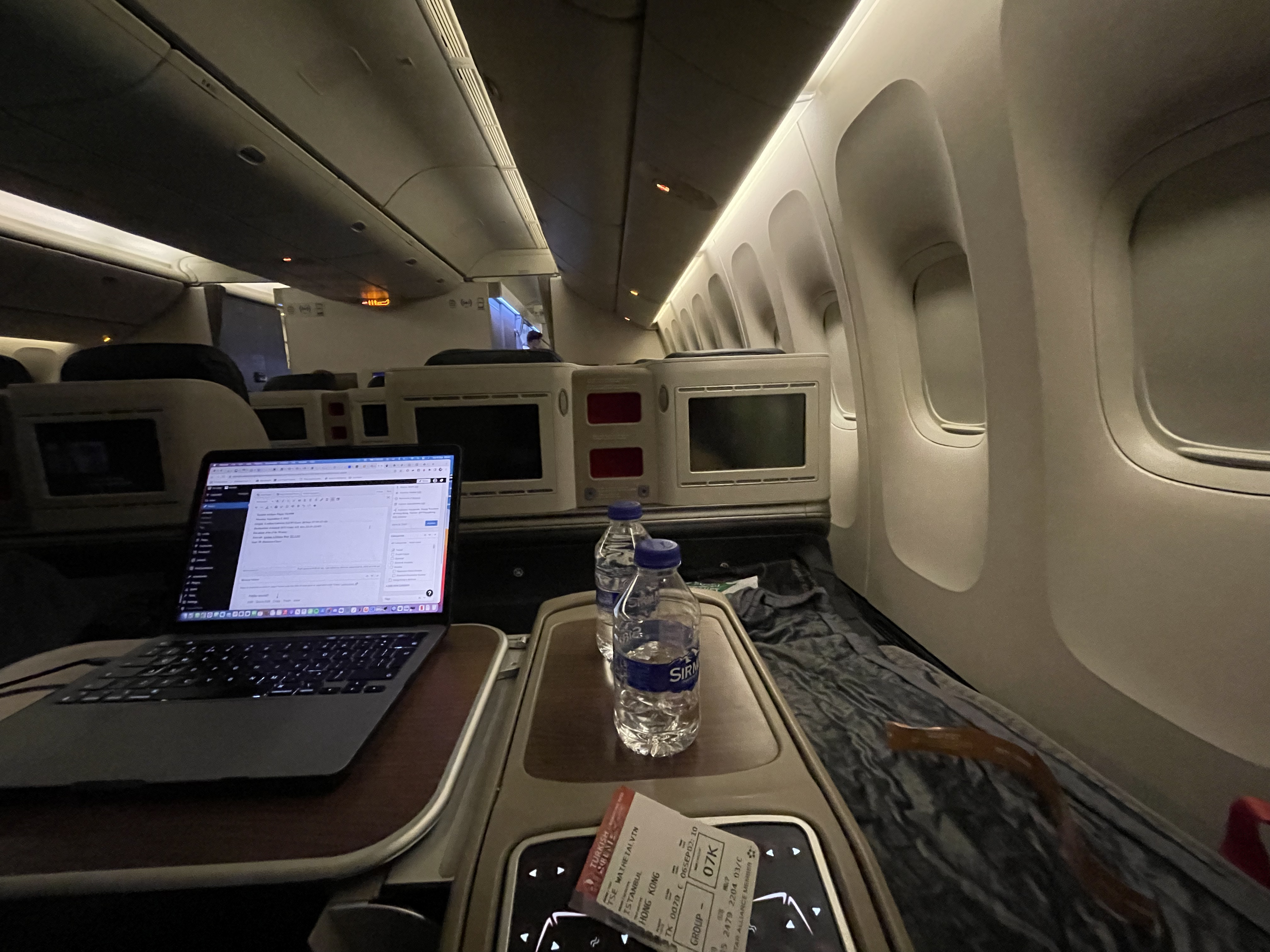 a laptop on a table in an airplane