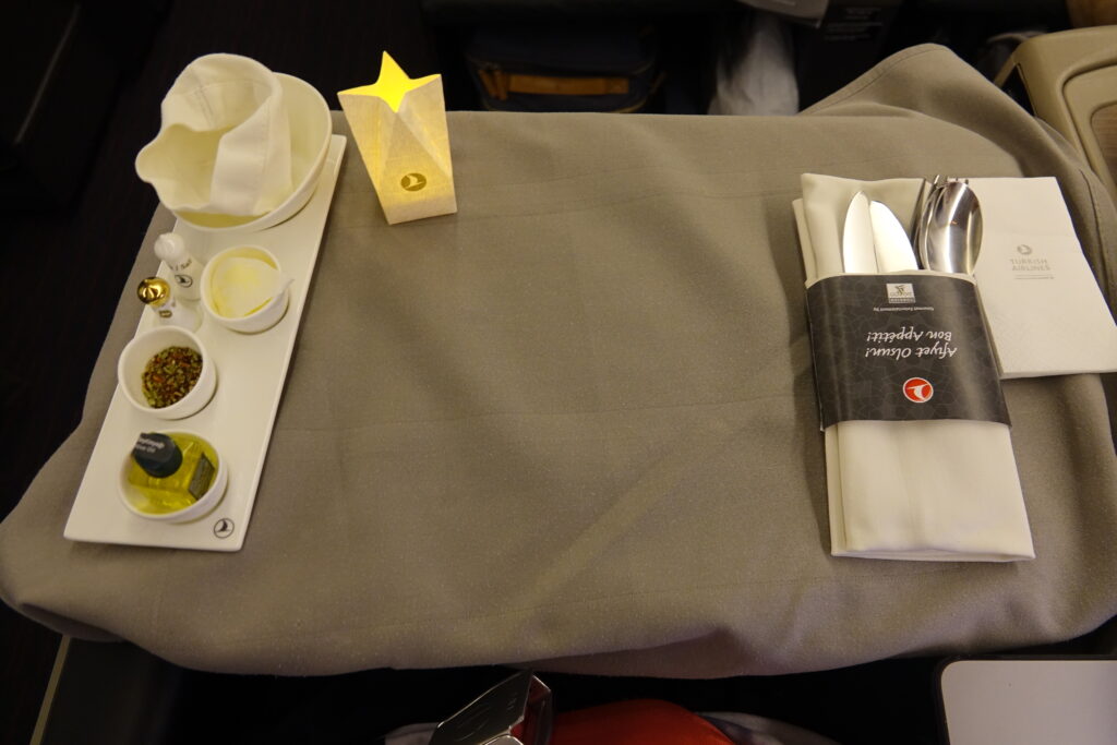a tray with condiments and napkins on a table