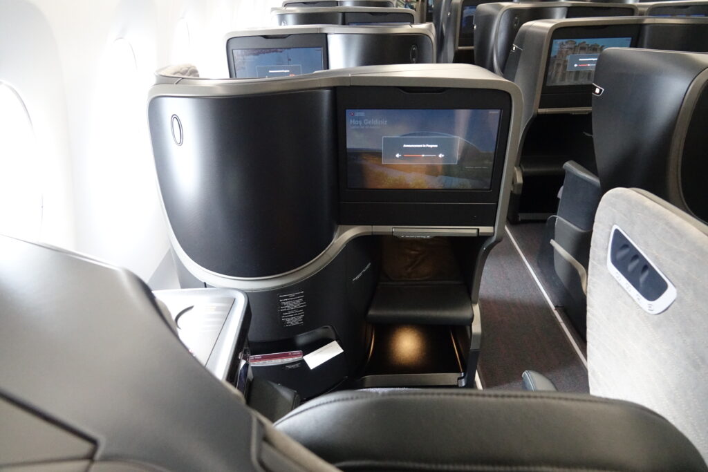 a row of seats with a television on the side