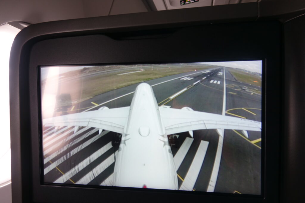 a screen showing an airplane landing on a runway